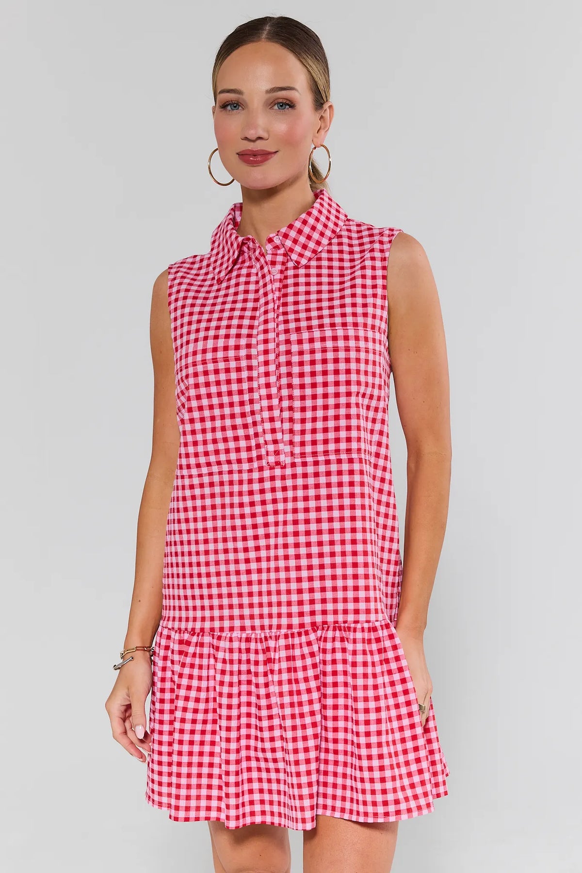 Woman wearing red gingham short dress with collared neckline and drop-waist ruffle hem - Front View | Avara