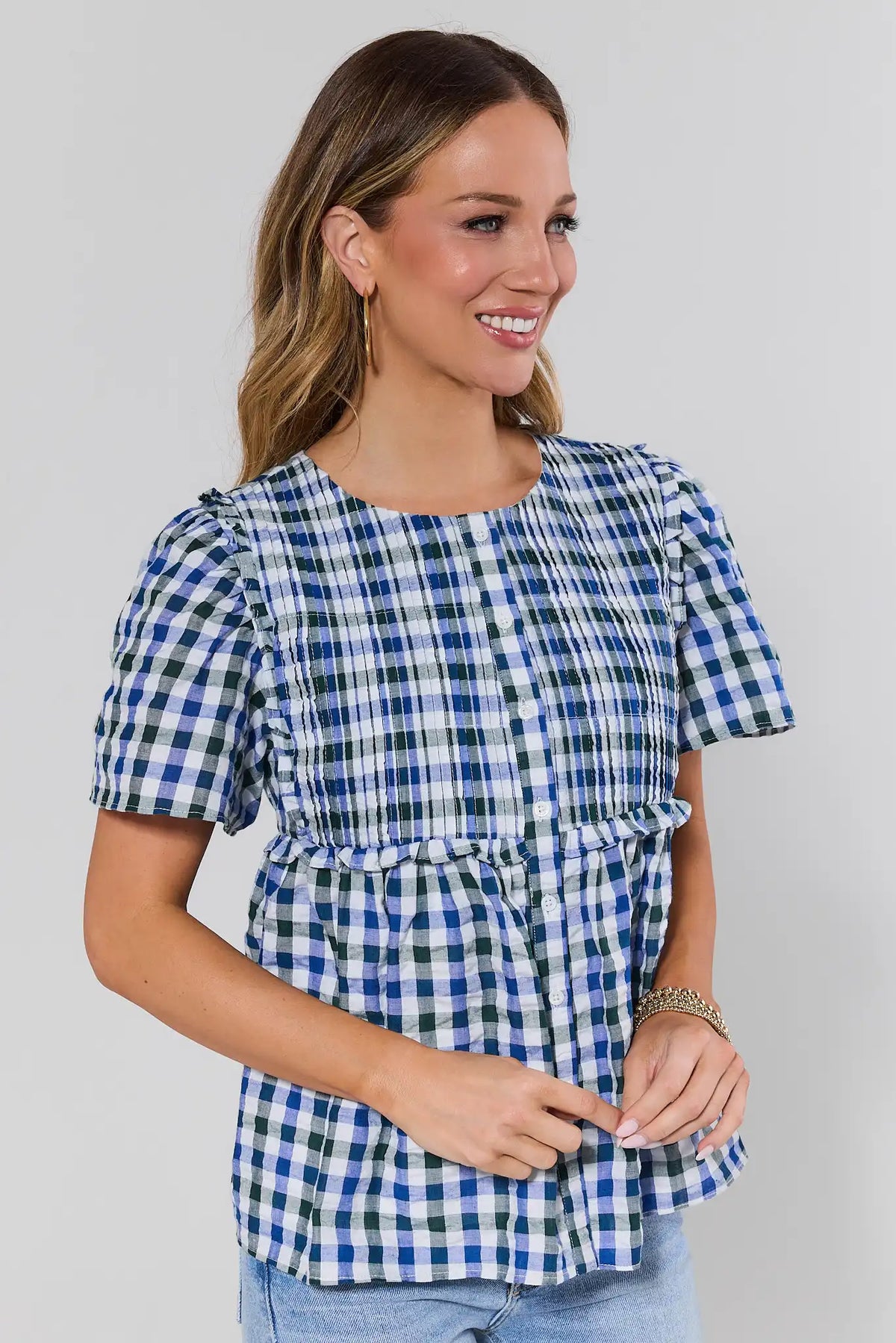Navy gingham peplum top with puff sleeves and ruffle waist - Side Angle View | Avara