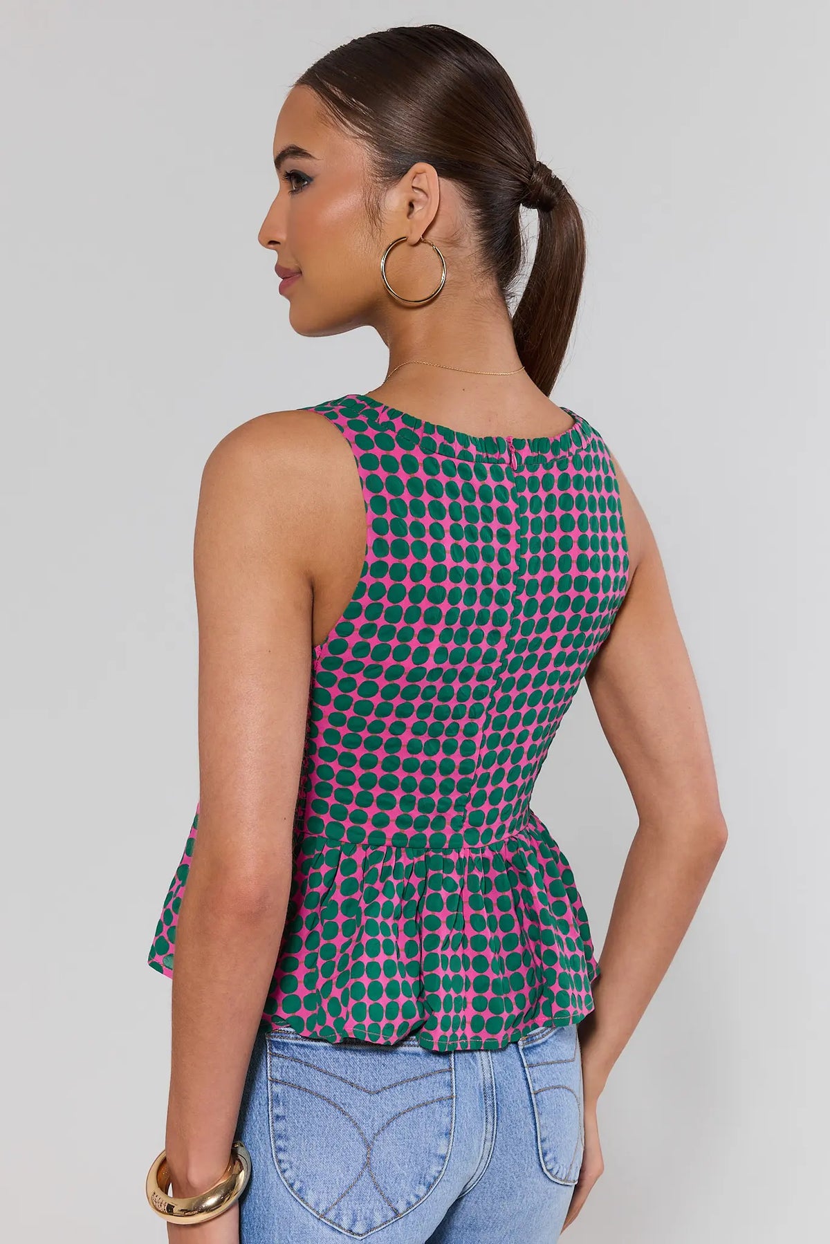 Pink Polka Dot Peplum Tank Top - Back View Showing Flared Peplum Silhouette | Avara