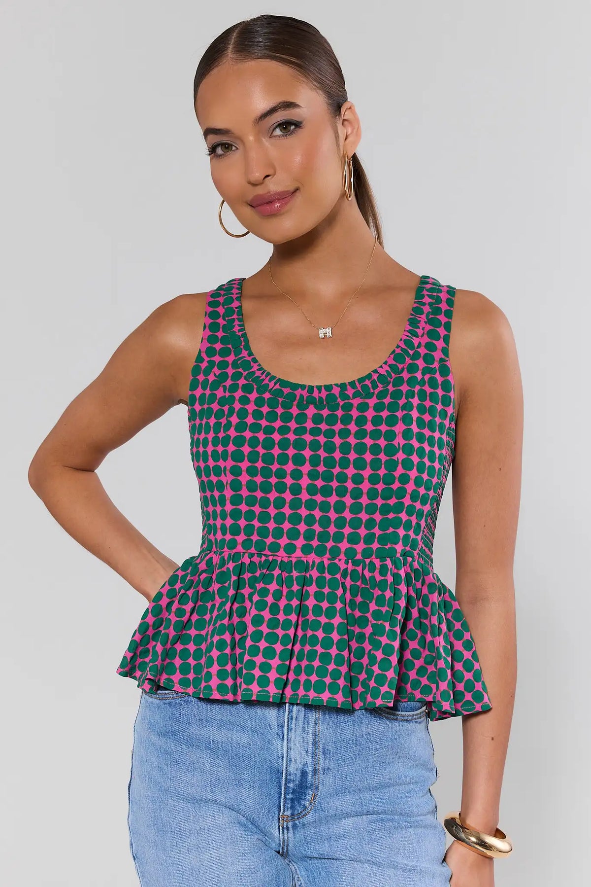Pink & Green Polka Dot Peplum Tank Top - Front View On Model with Jeans | Avara