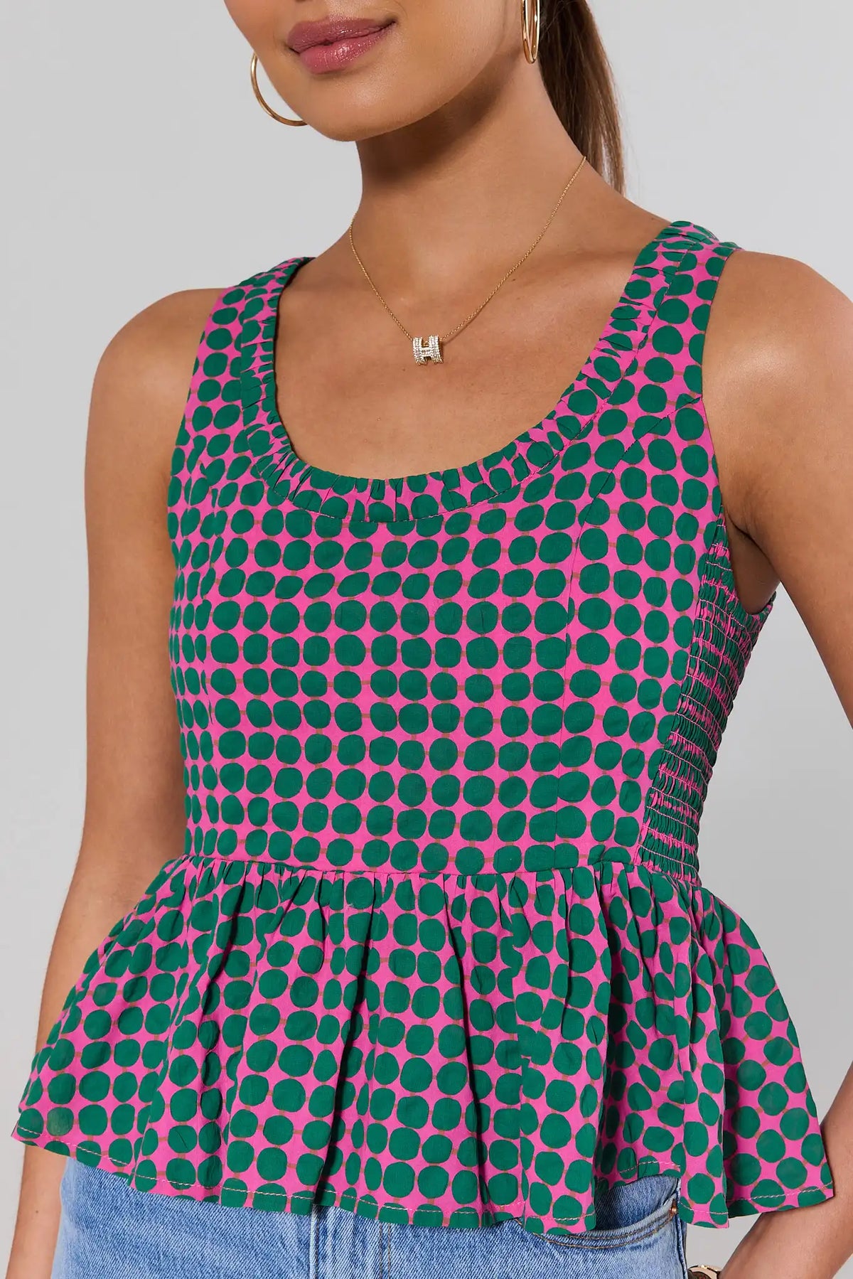 Pink Polka Dot Peplum Tank Top - Close-Up Scoop Neckline & Peplum Hem Detail | Avara