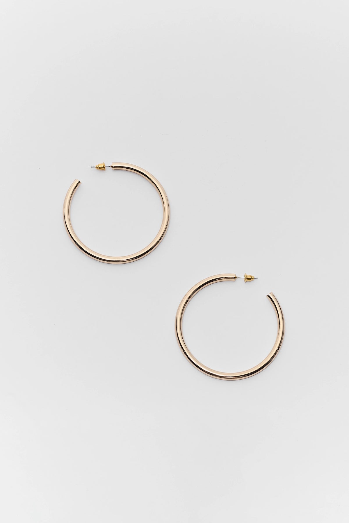 Emily Gold Medium Hoop Earrings - Flat Lay, Polished Gold-Tone Tube Hoops | Avara