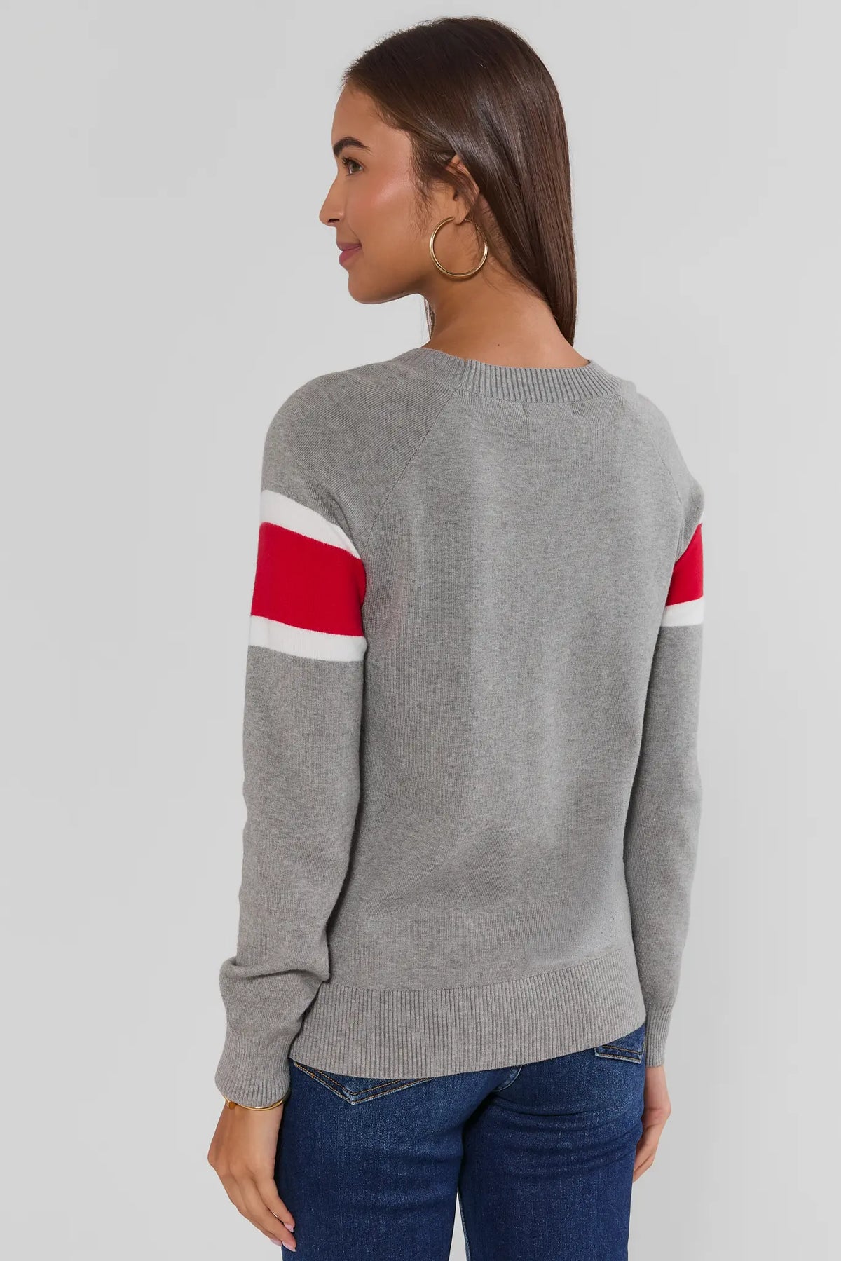 Dylan Red Stripe Sweater back view showing red and white sleeve stripes on heather gray knit, paired with blue jeans | Avara