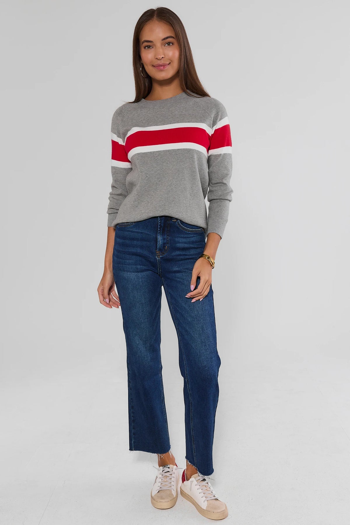 Dylan Red Stripe Sweater styled look, gray knit crewneck with red and white stripes, cropped dark jeans and white sneakers | Avara