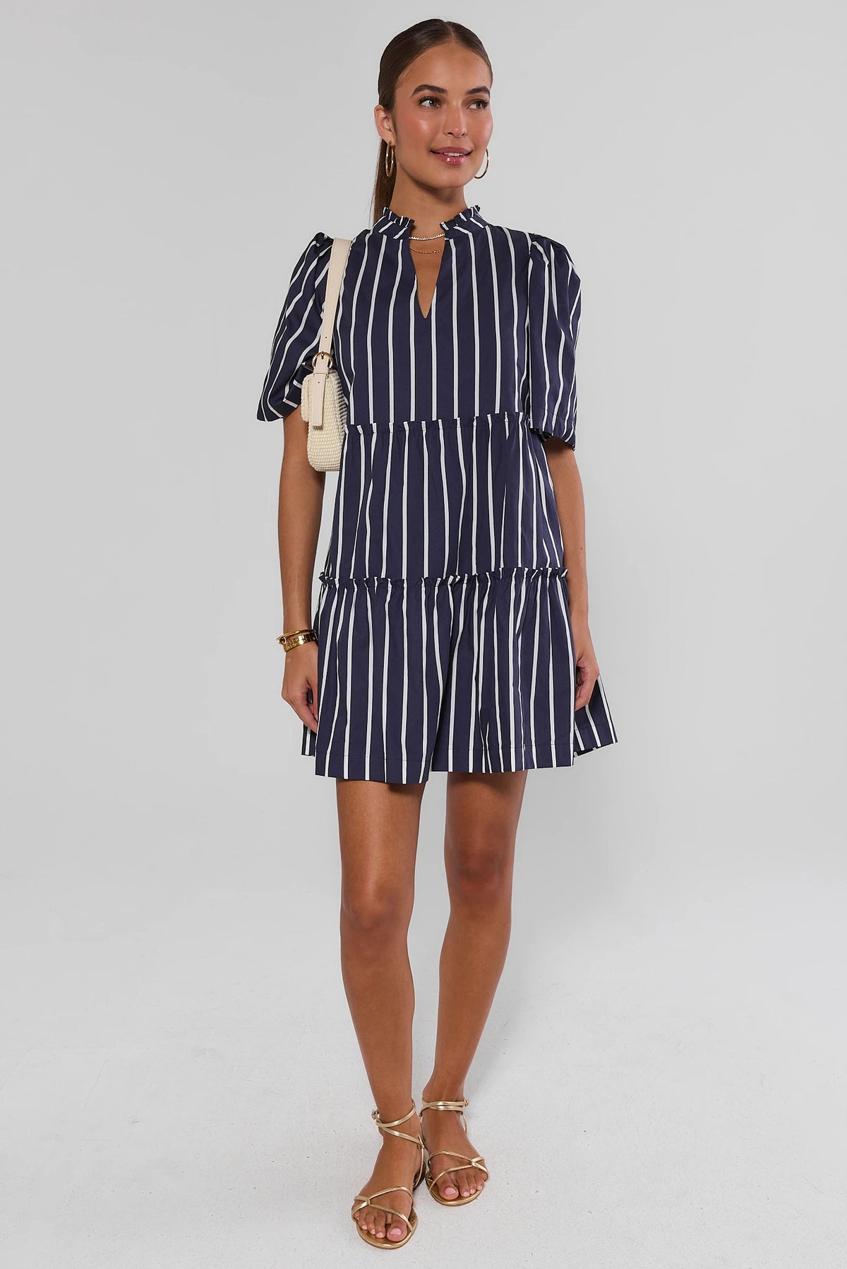 Navy blue striped short dress styled with gold sandals and woven bag - Full Length Front | Avara