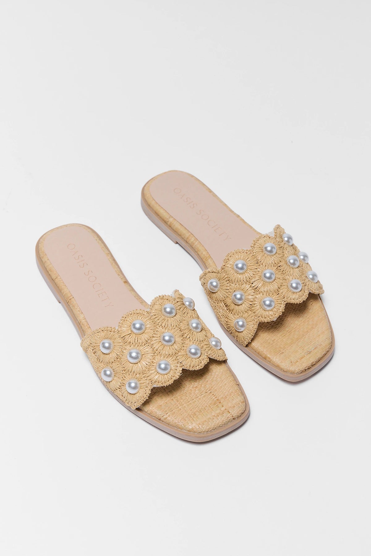 Tan pearl raffia slide sandals pair - Angled Top View showing floral woven detail | Avara