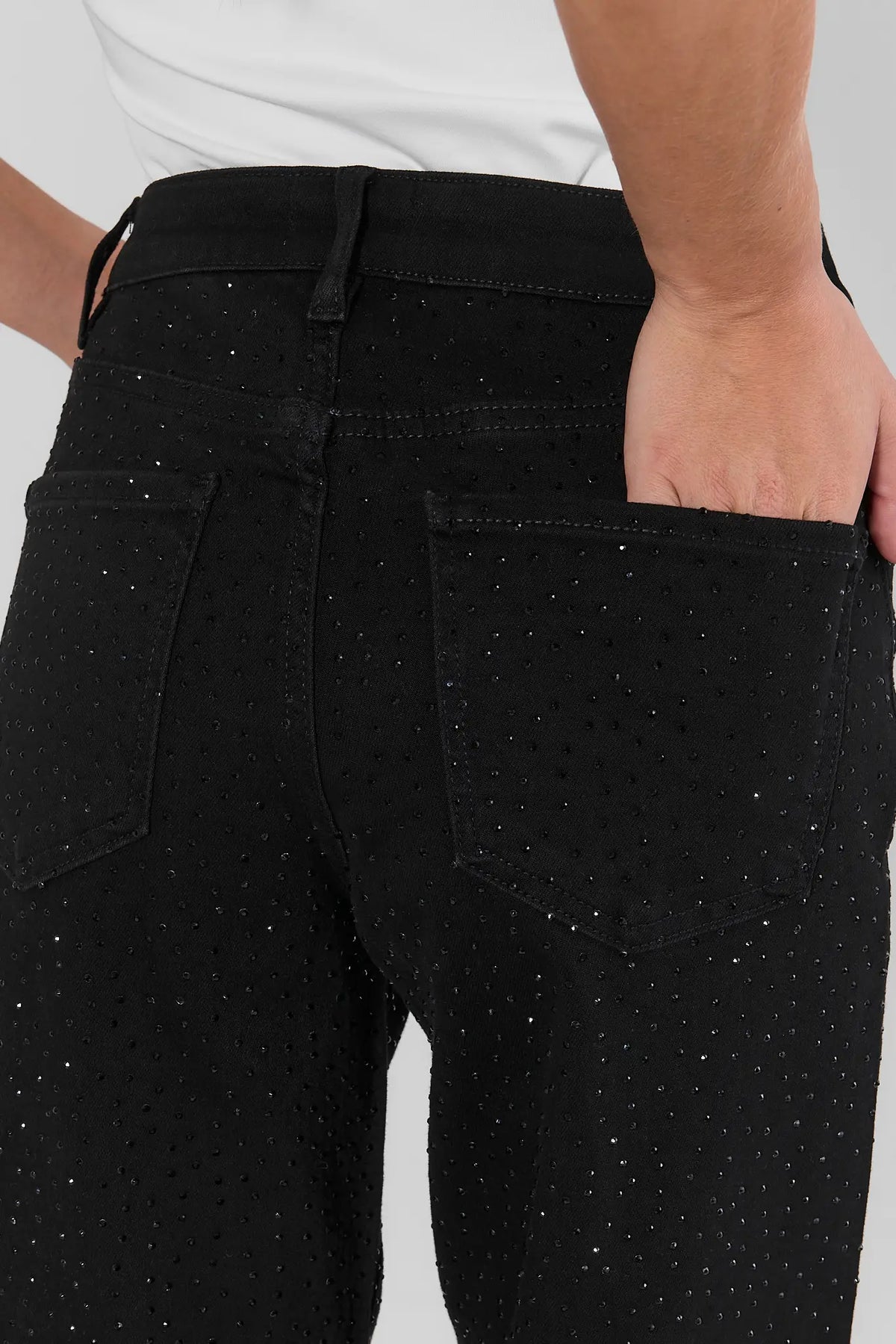 Black rhinestone jeans back waistband and pocket close-up with allover crystal embellishment detail | Avara