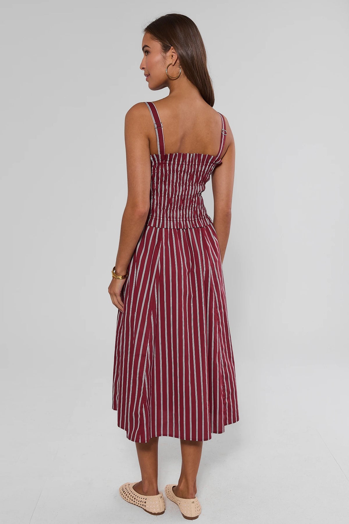 Maroon and white striped smocked midi dress showing adjustable straps and flowy A-line skirt - Back View | Avara