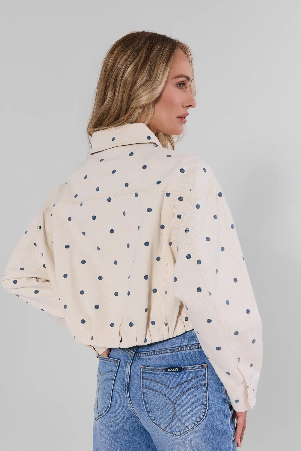 White Polka Dot Cropped Denim Jacket back view showing navy dot print and cropped hemline | Avara