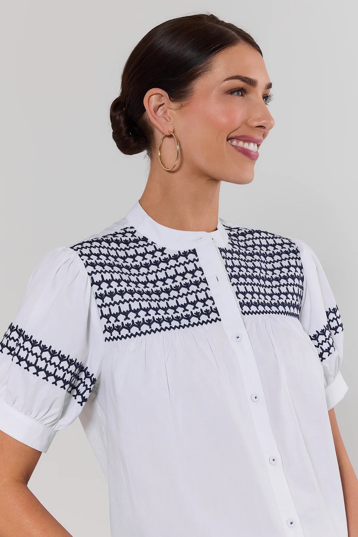 Trudy White Navy Embroidered Top - Close-Up Detail of navy embroidery on yoke and puff sleeves | Avara