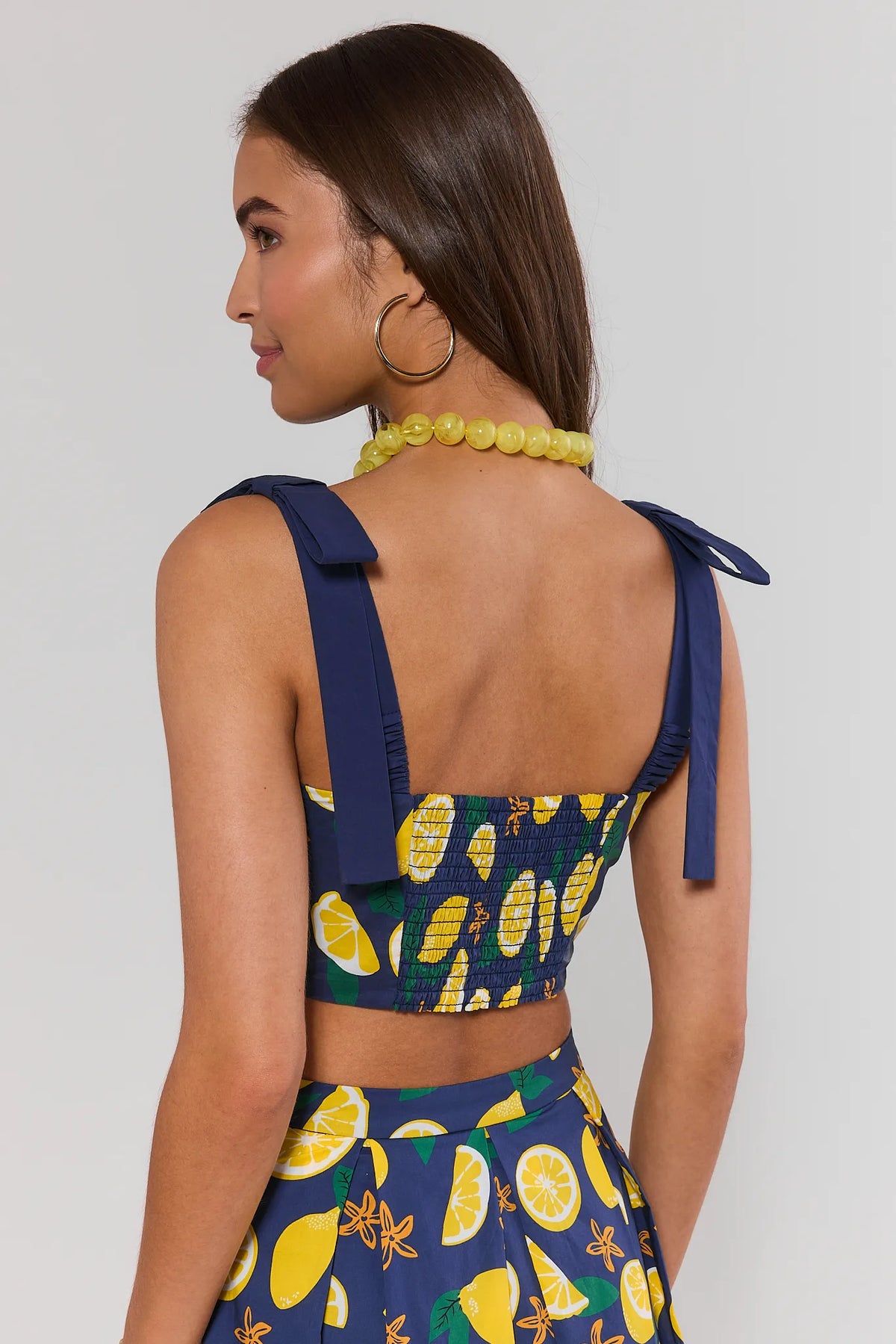 Navy lemon print tank top back view showing smocked detail and tie shoulder straps | Avara
