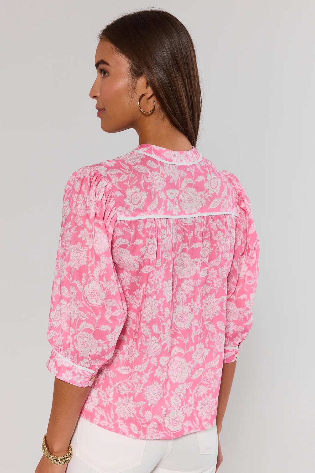 Parker Pink Floral Print Top back view with puff sleeves and white contrast piping, styled with white jeans | Avara