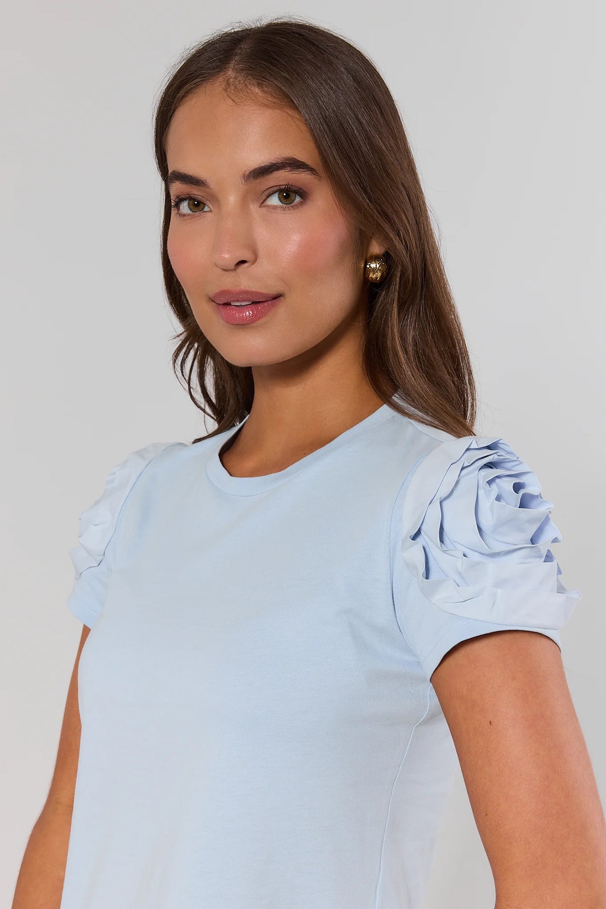Close-up of light blue Kendall Floral Appliqué Top with rosette sleeve detail - Front Close-Up | Avara