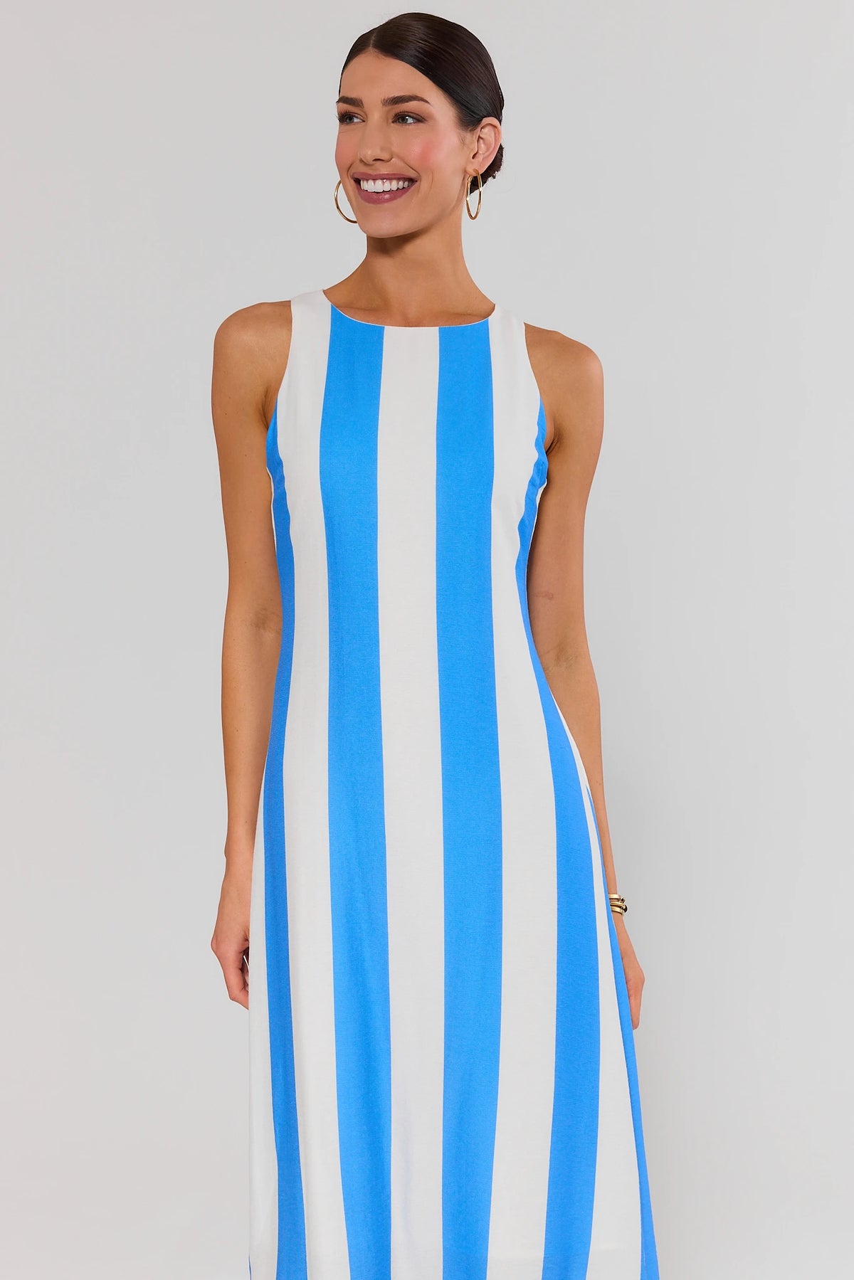 Blue striped midi dress front view, relaxed flowy silhouette, bold vertical stripe print | Avara