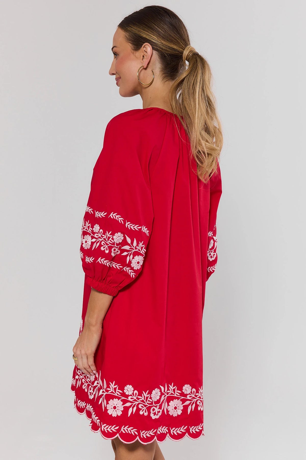 Tara Red Embroidered Short Dress, back view, white floral embroidery and scalloped hem detail | Avara