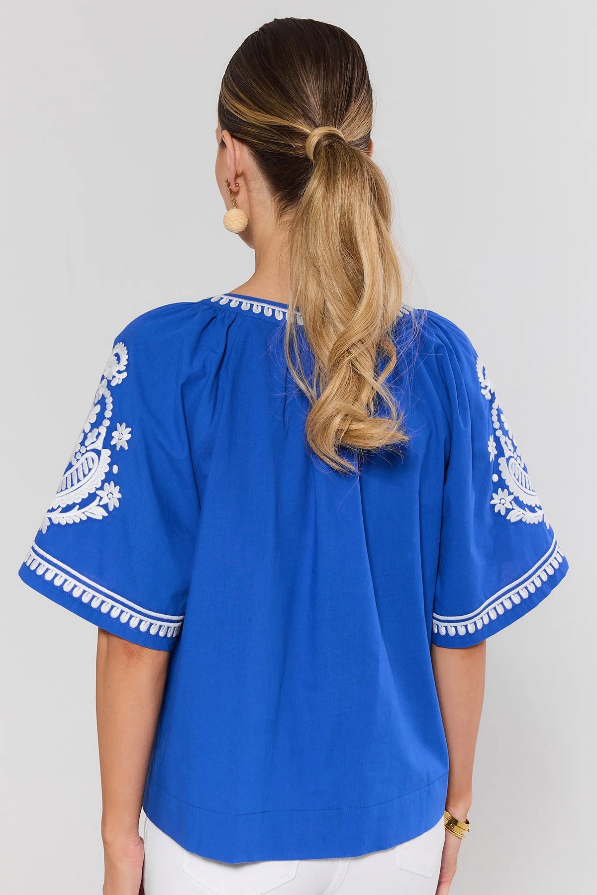 Essie Blue Embroidered Top - White Floral Embroidered Flutter Sleeves, Back View On Model | Avara