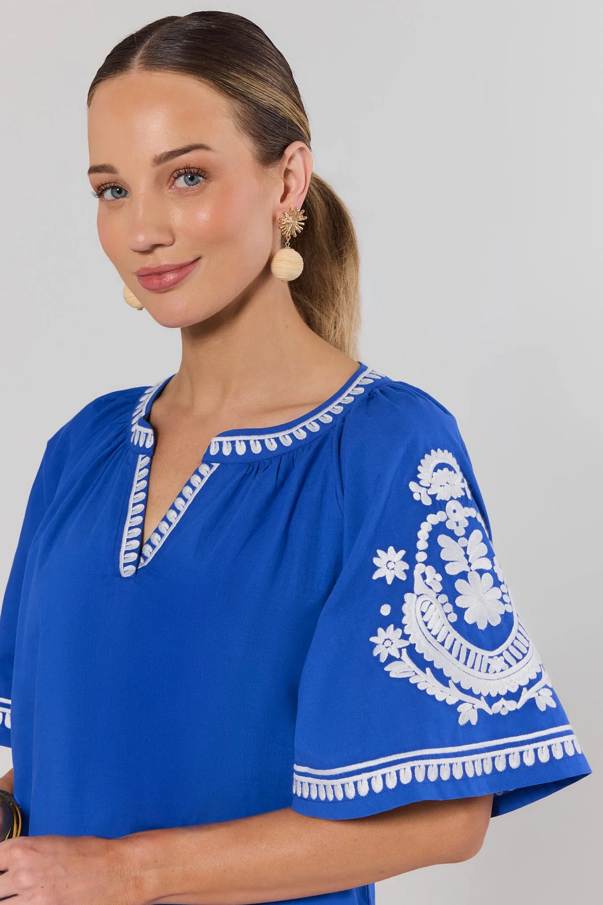 Essie Blue Embroidered Top - Split Neckline and White Floral Sleeve Embroidery Close-Up Detail | Avara