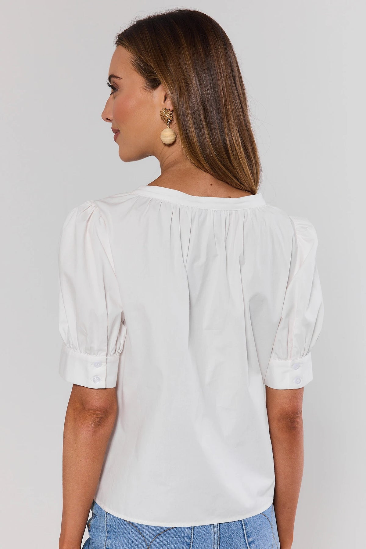 White Embroidered Button Up Top showing puff sleeves and clean back, back view on model | Avara