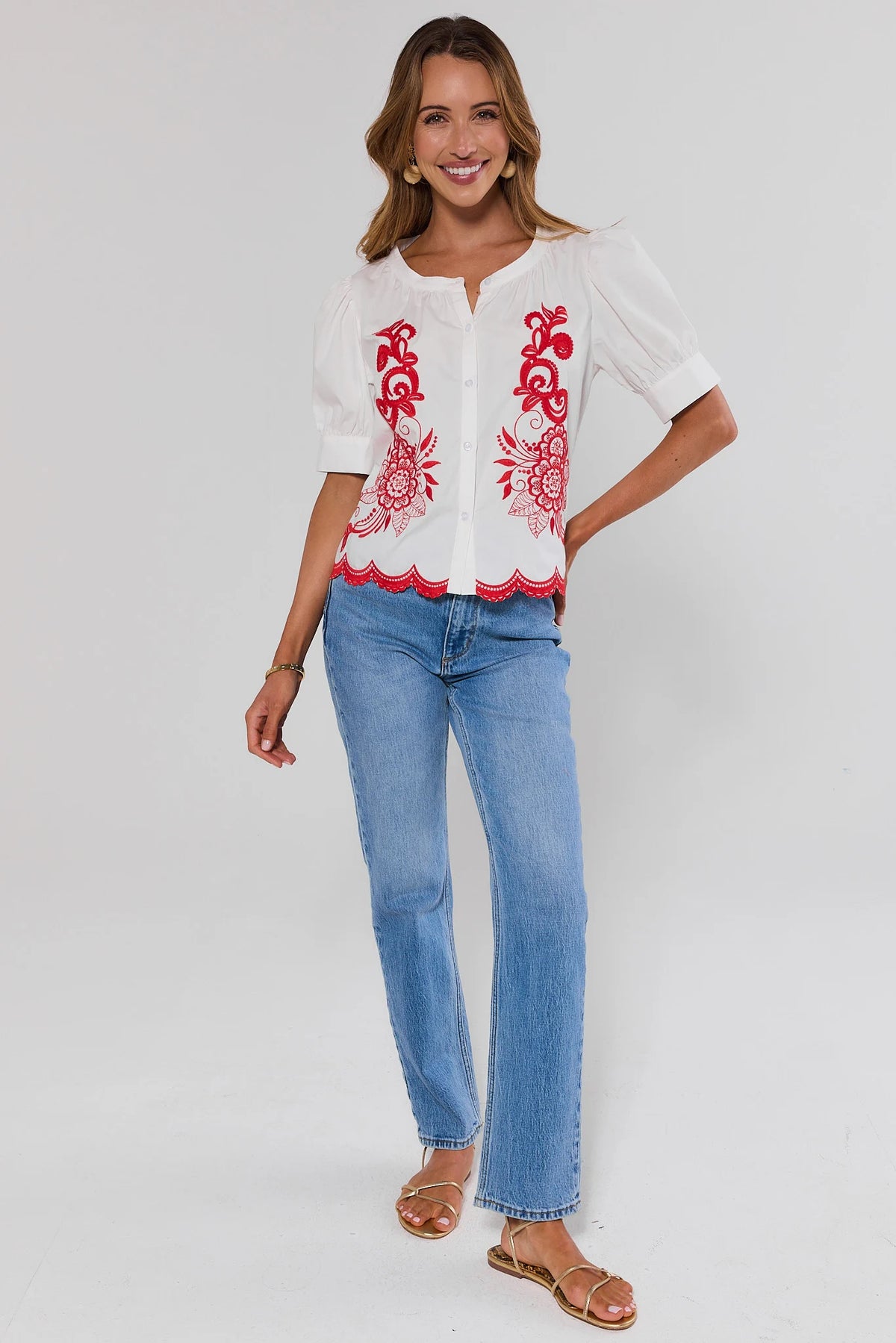 White Embroidered Button Up Top with red floral detail styled with blue jeans, full-length front view | Avara