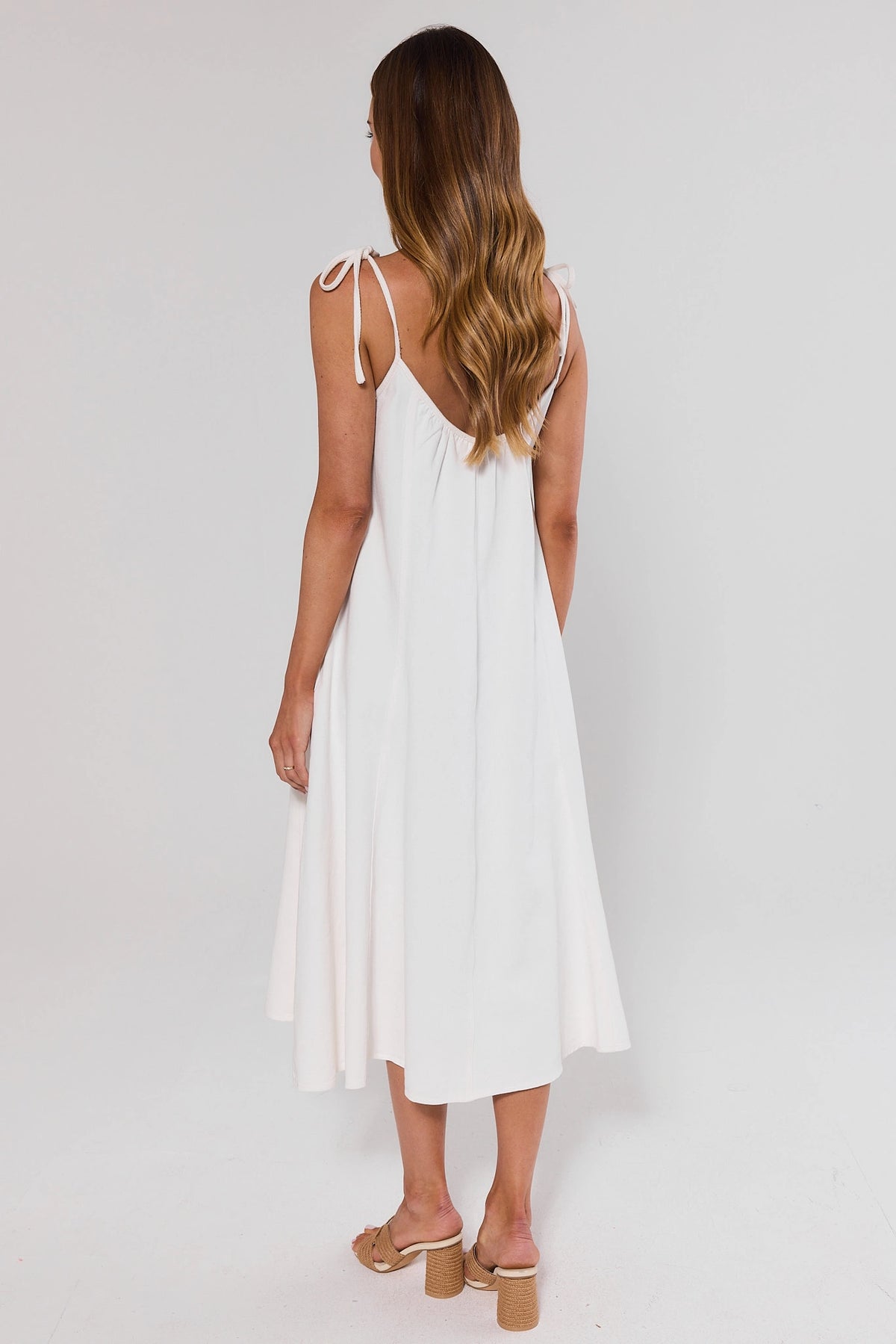 White Denim Tie Midi Dress back view showing open back and tie strap detail | Avara