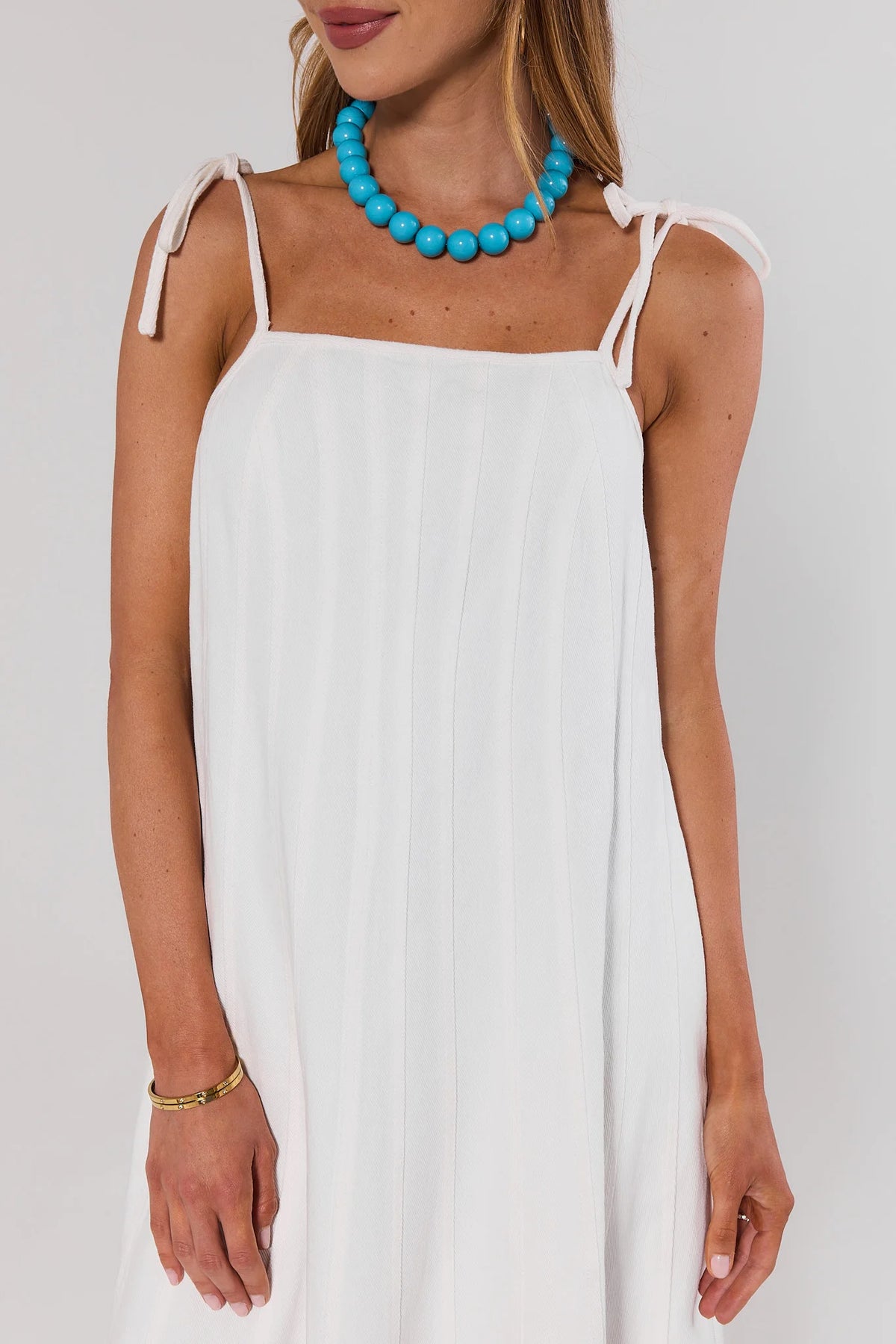 White Denim Tie Midi Dress close-up showing tie strap and square neckline detail | Avara