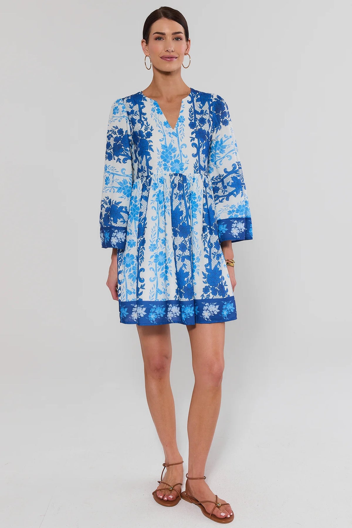 Blue and white floral print short dress, full-length front view styled with tan sandals | Avara