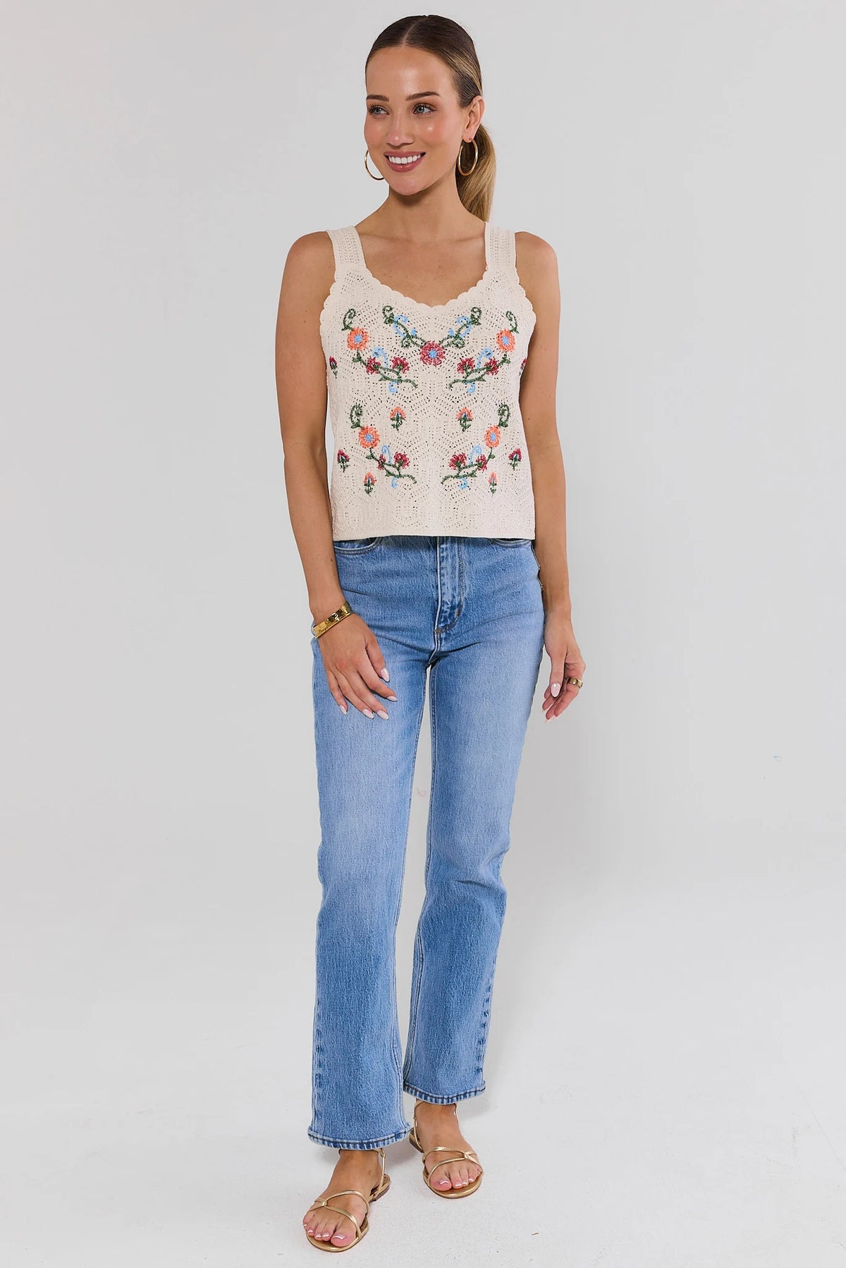 White crochet floral tank top styled with blue jeans and gold sandals - Full Length On Model | Avara