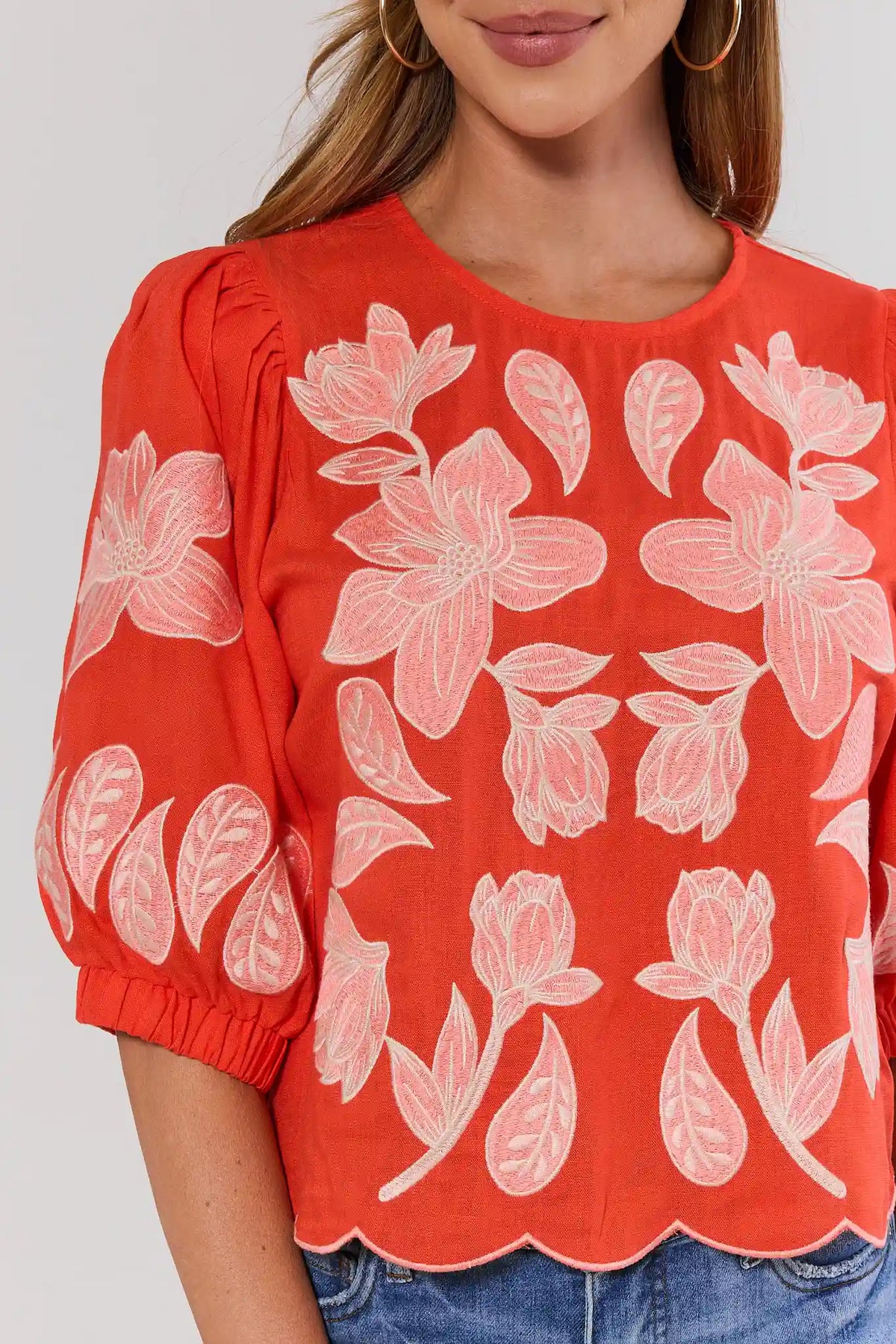 Close-up of orange THML floral applique top showing embroidered detail and scalloped hem | Avara