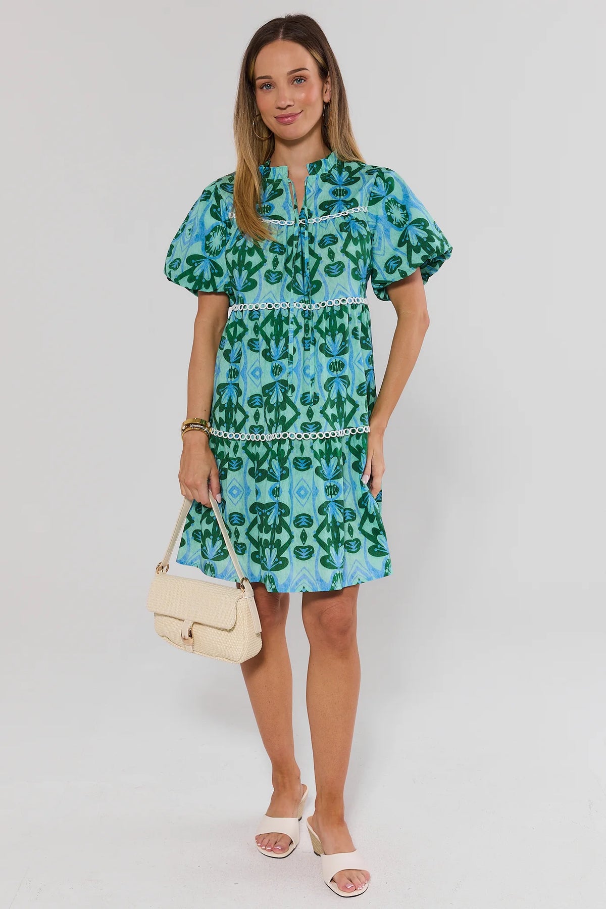 Reina Green Printed Short Dress front view styled with cream woven bag and white mules | Avara