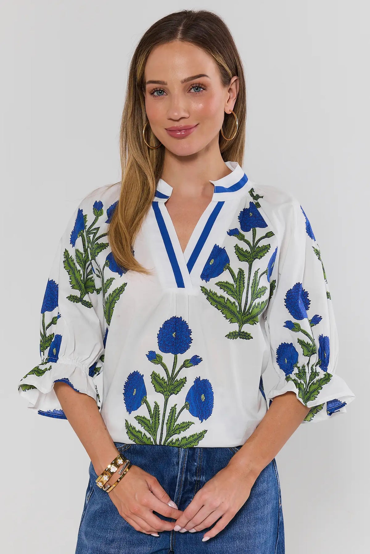 Angelica White Floral Print Top with blue V-neckline trim and ruffle sleeves - Front View | Avara