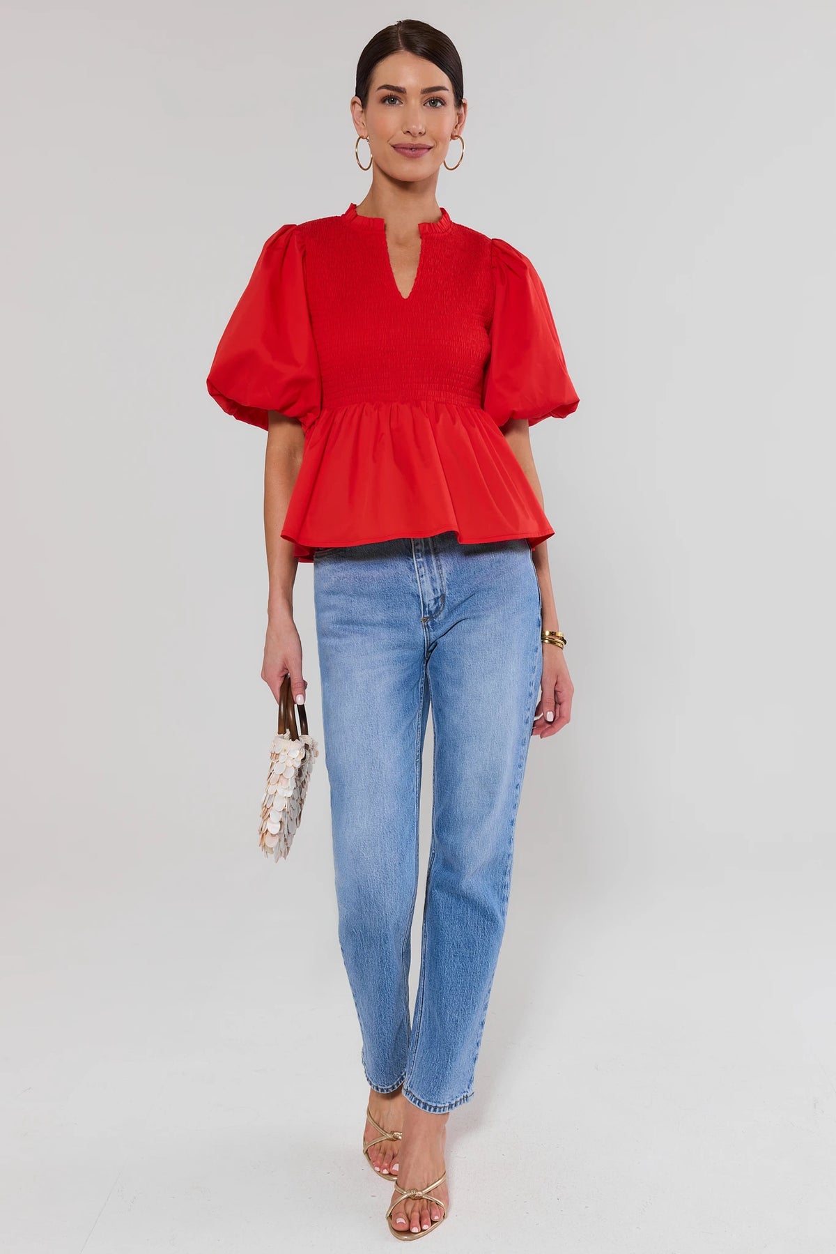 Red Smocked Peplum Top styled with light wash jeans and gold sandals - Full Length View | Avara