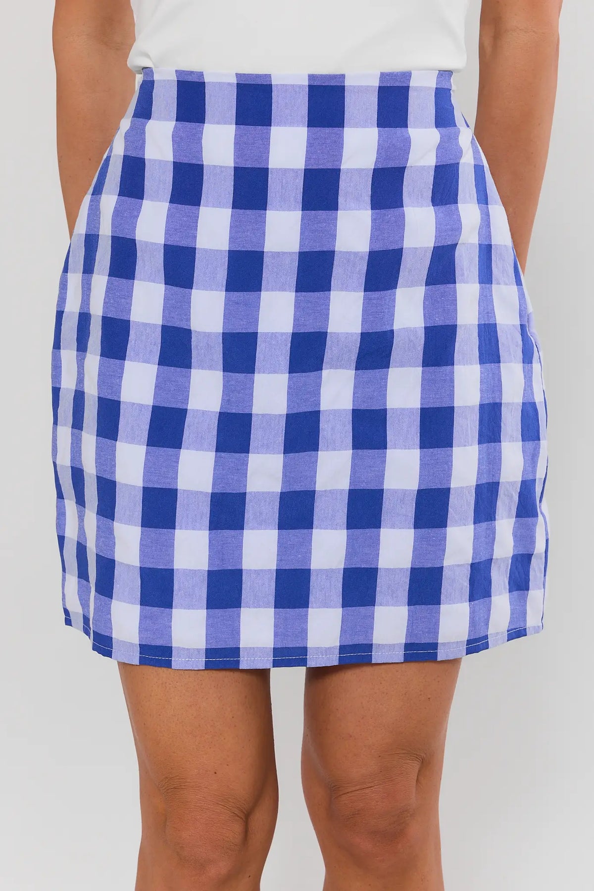 Blue gingham mini skirt close-up, large check print, high-rise waist - Detail View | Avara