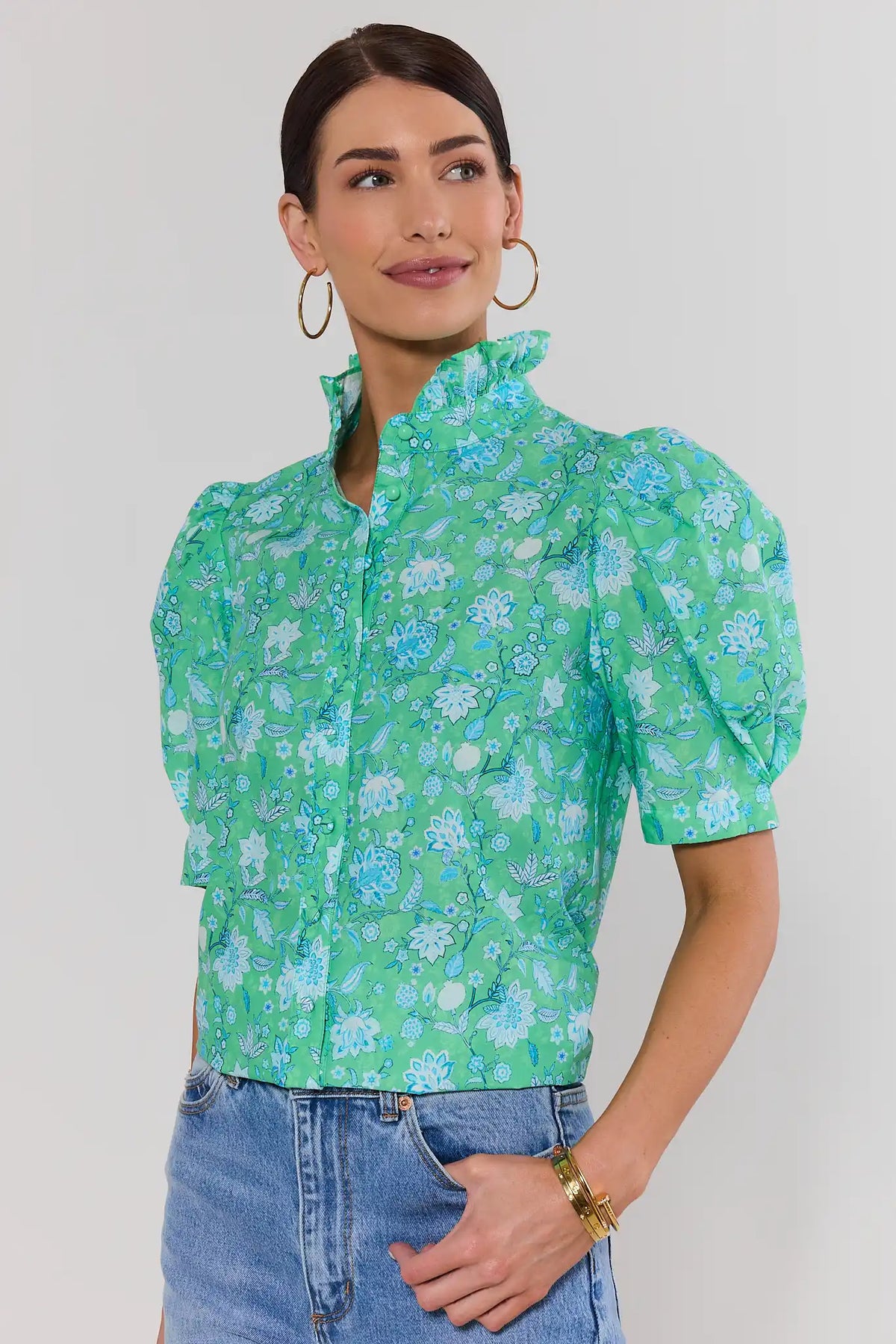 Woman wearing green floral puff sleeve button-up top with jeans - Front View | Avara