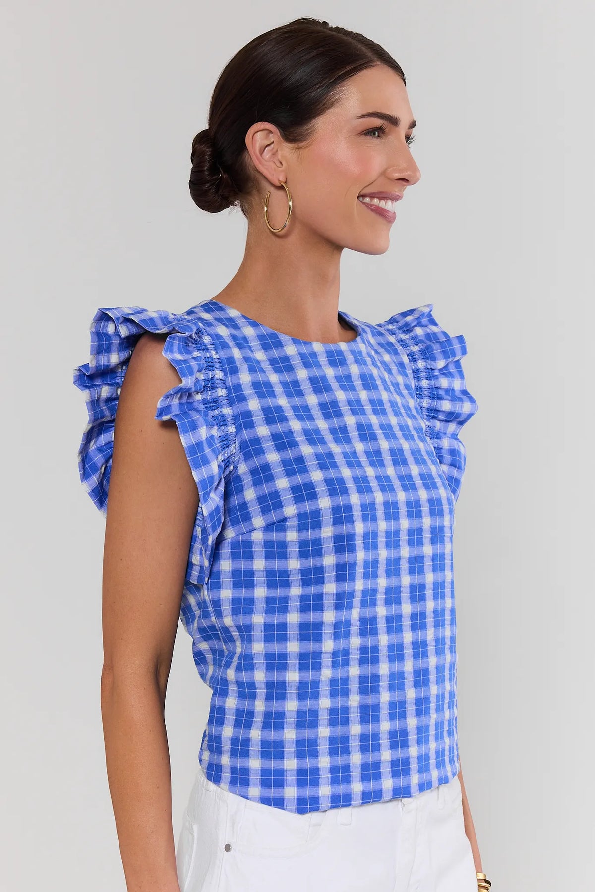 Bethany Blue Gingham Flutter Sleeve Top, side view paired with white denim, smocked ruffle sleeves | Avara