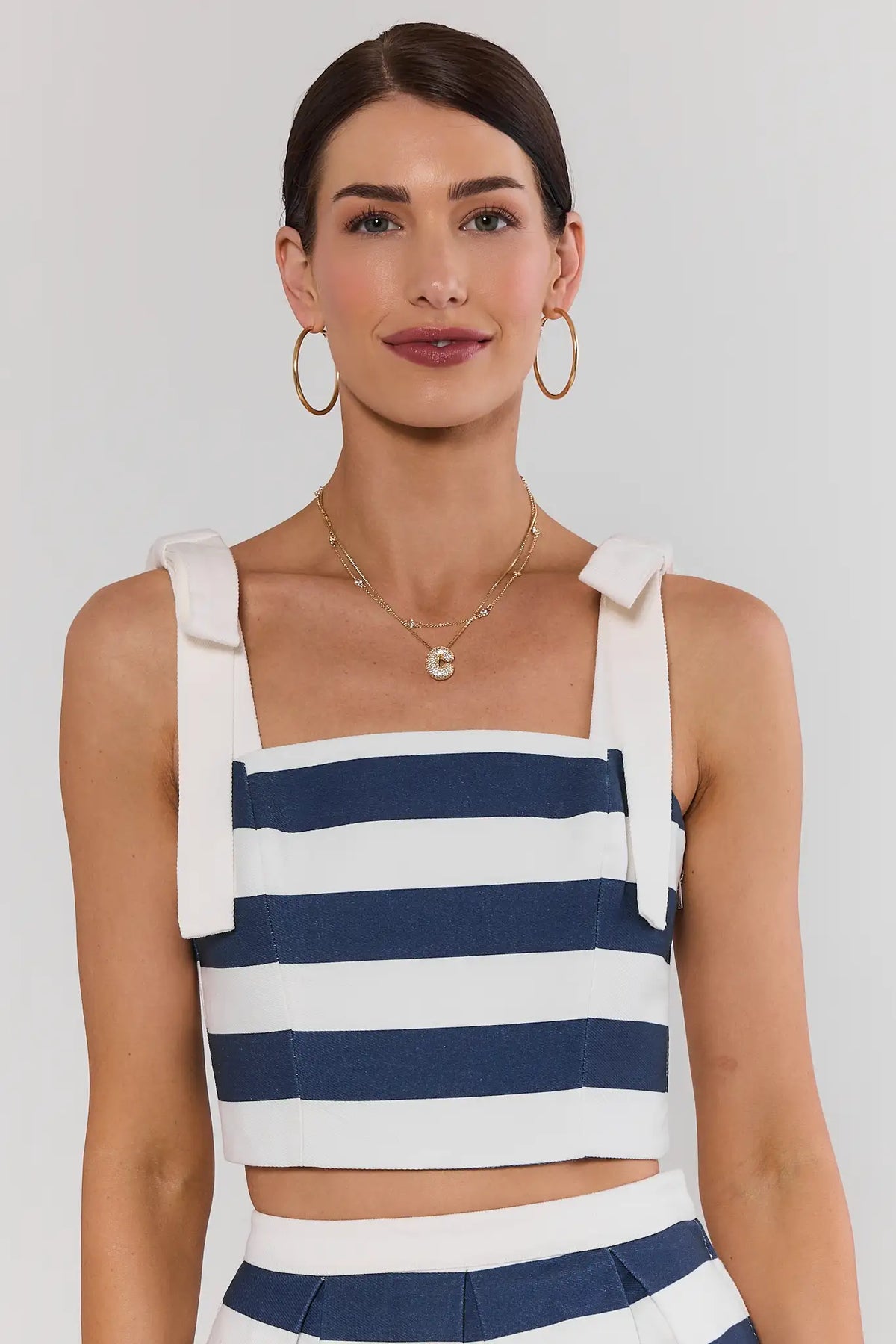 Navy striped cropped tank top with square neckline and bow shoulder straps, front view on model | Avara
