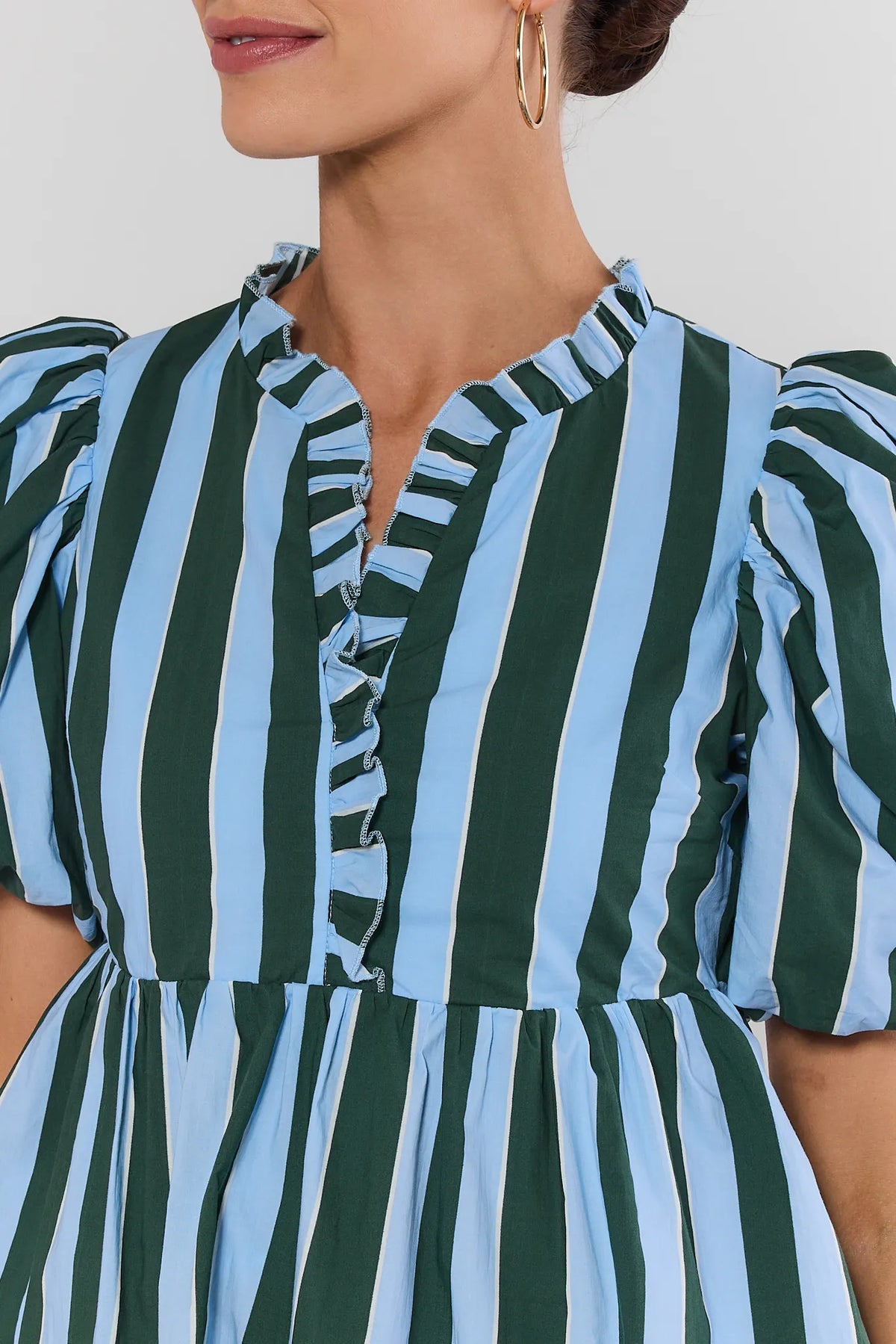 Blue striped peplum blouse ruffle neckline and puff sleeve close-up detail | Avara
