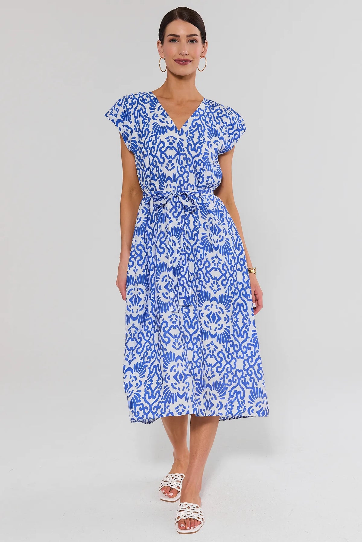 Woman wearing blue printed tie waist midi dress with white sandals - Full Length Front View | Avara