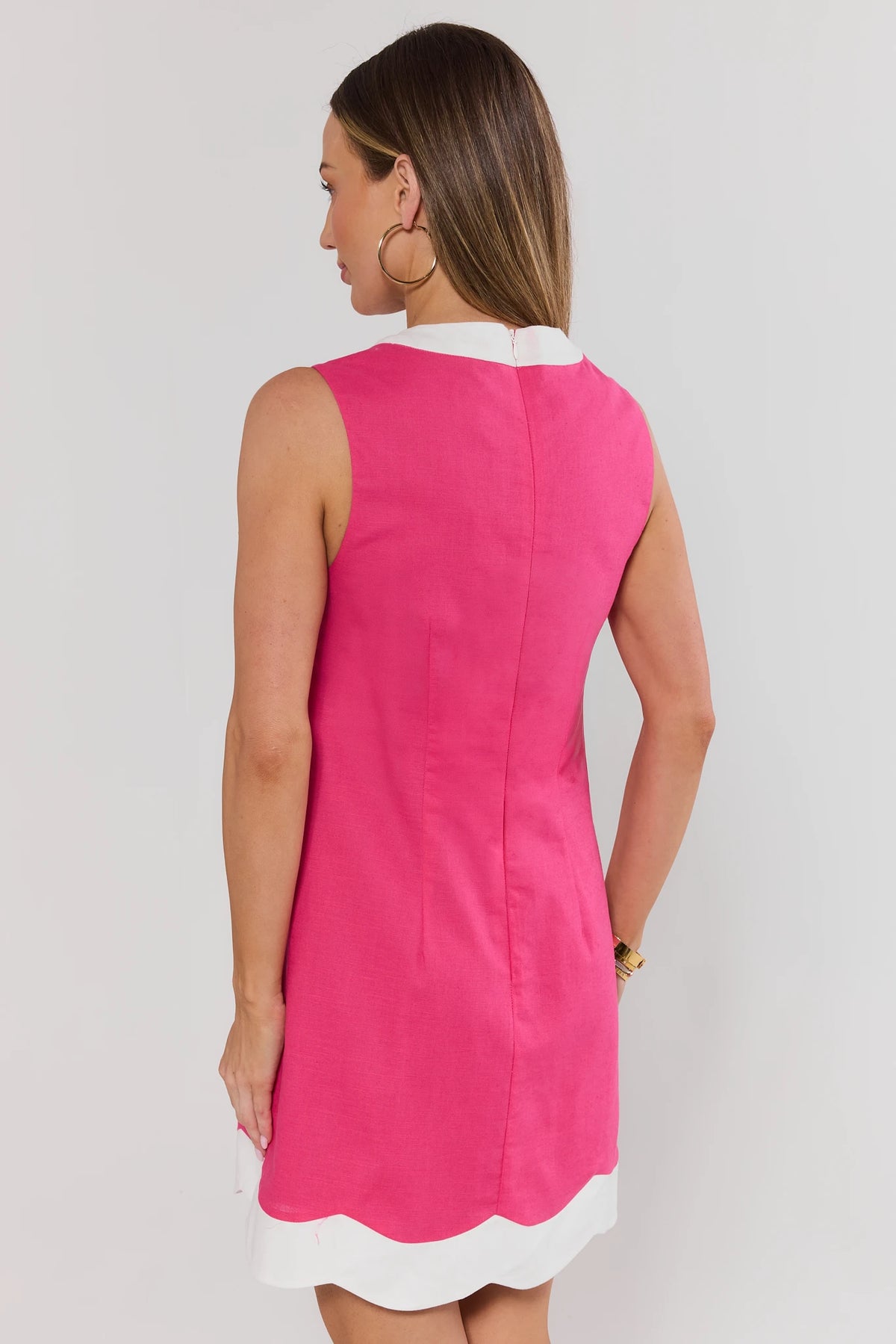 Pink contrast-trim short dress showing back zipper and white scalloped hem detail - Back View | Avara