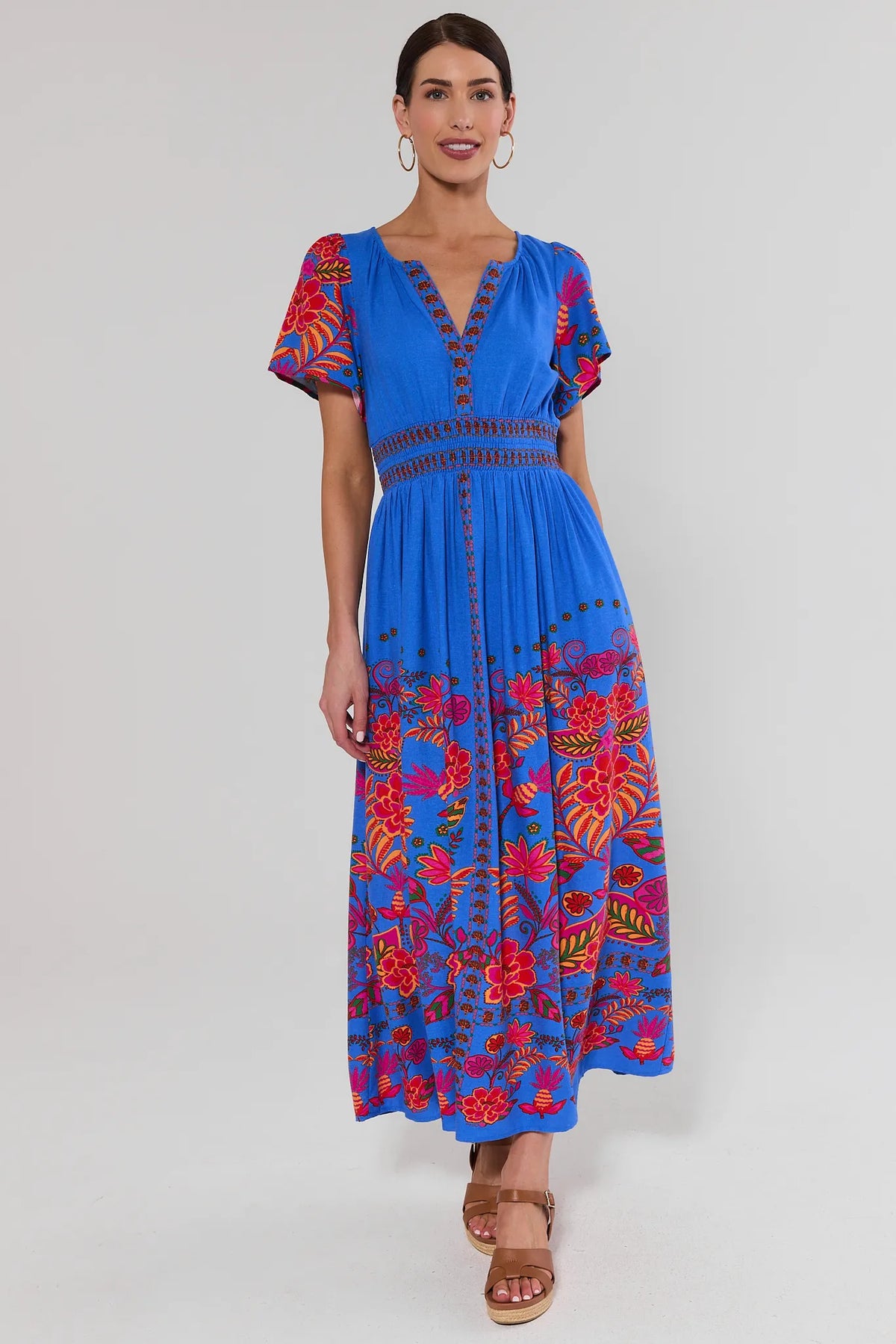 Blue multi printed modest maxi dress full length front view, colorful floral print, styled with wedges | Avara