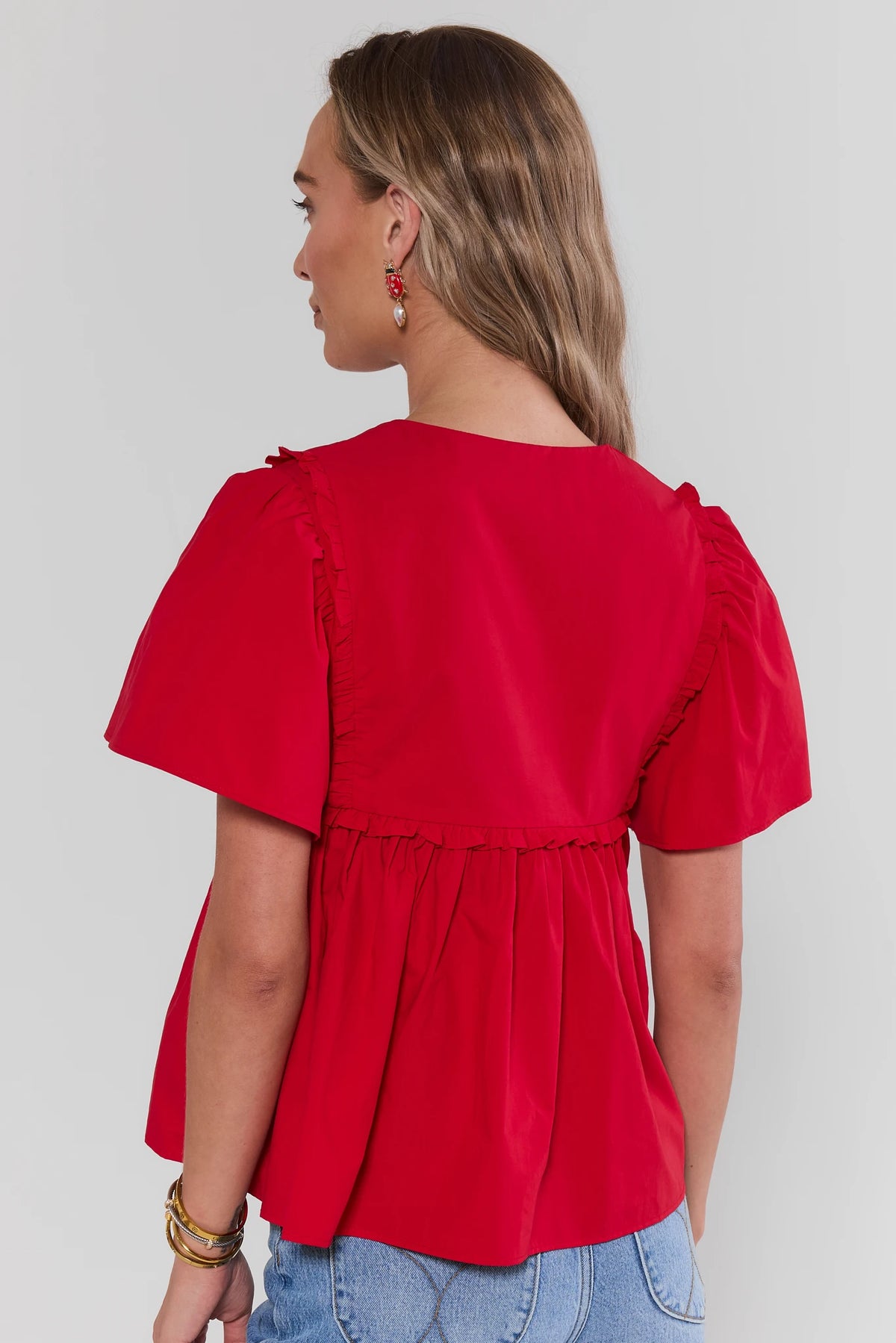 Libby Red Smocked Peplum Top showing ruffle trim and flutter sleeve detail - Back View | Avara