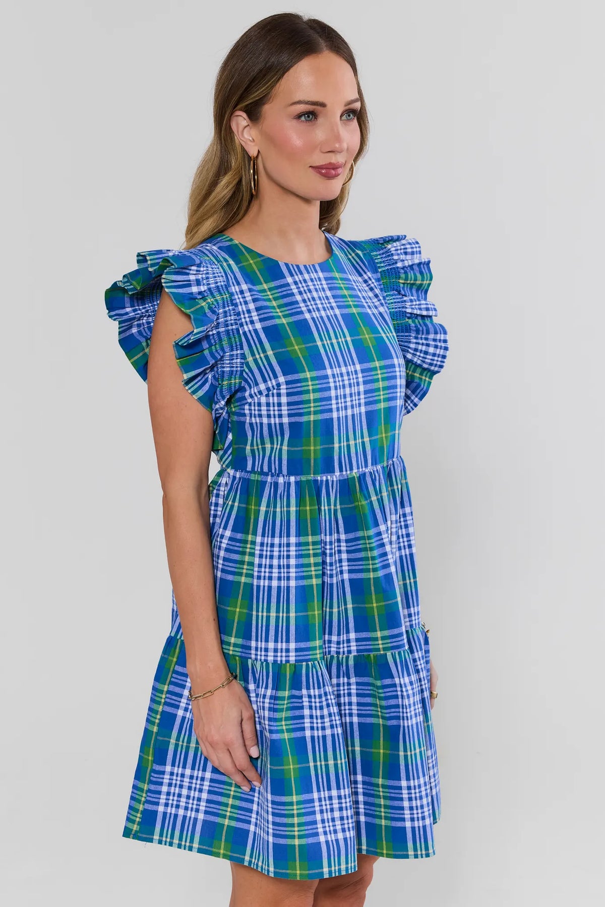Della Blue Plaid Short Dress side angle view showing flutter sleeve detail and tiered back | Avara