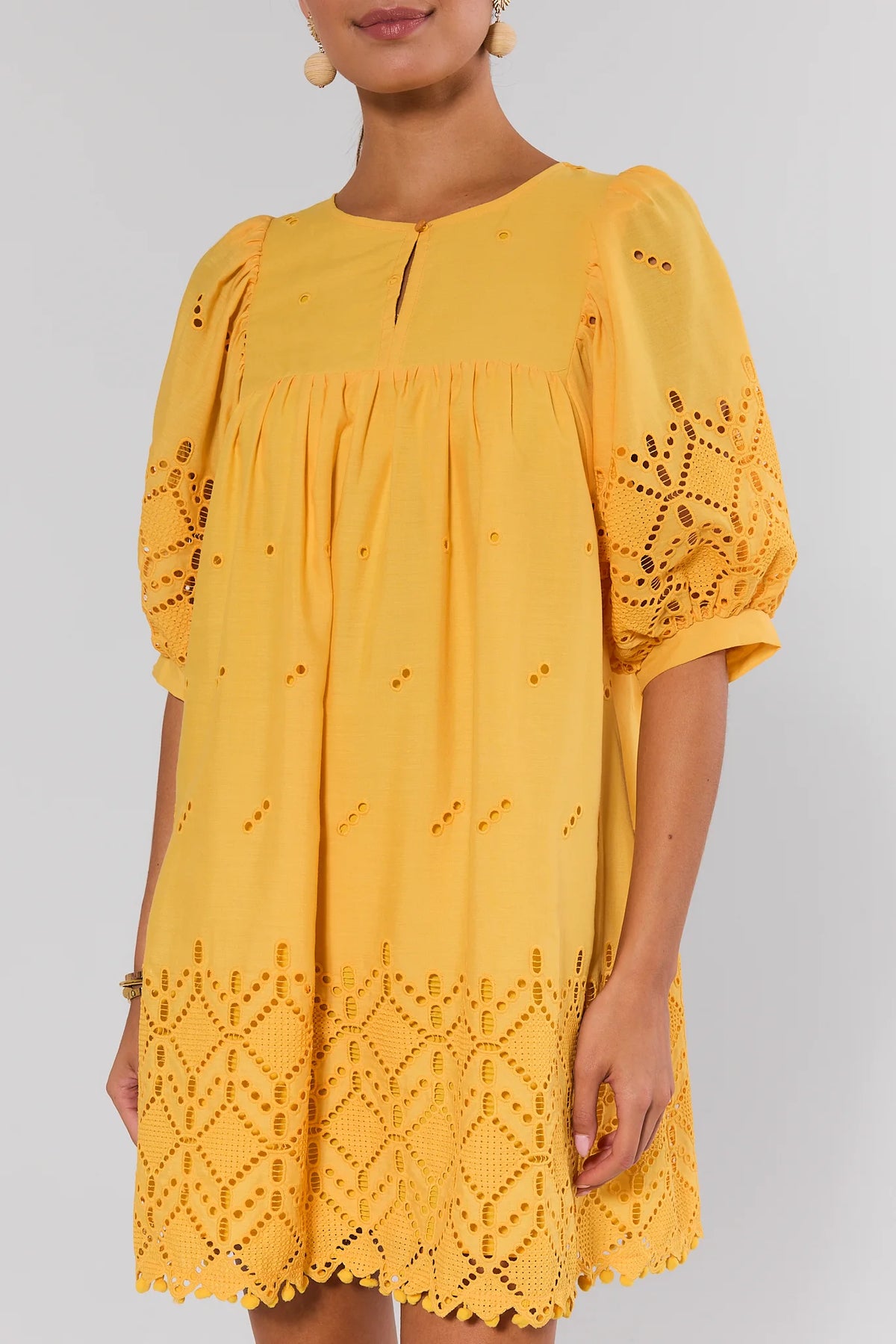 Yellow Eyelet Short Dress close-up showing embroidered puff sleeves and keyhole neckline | Avara