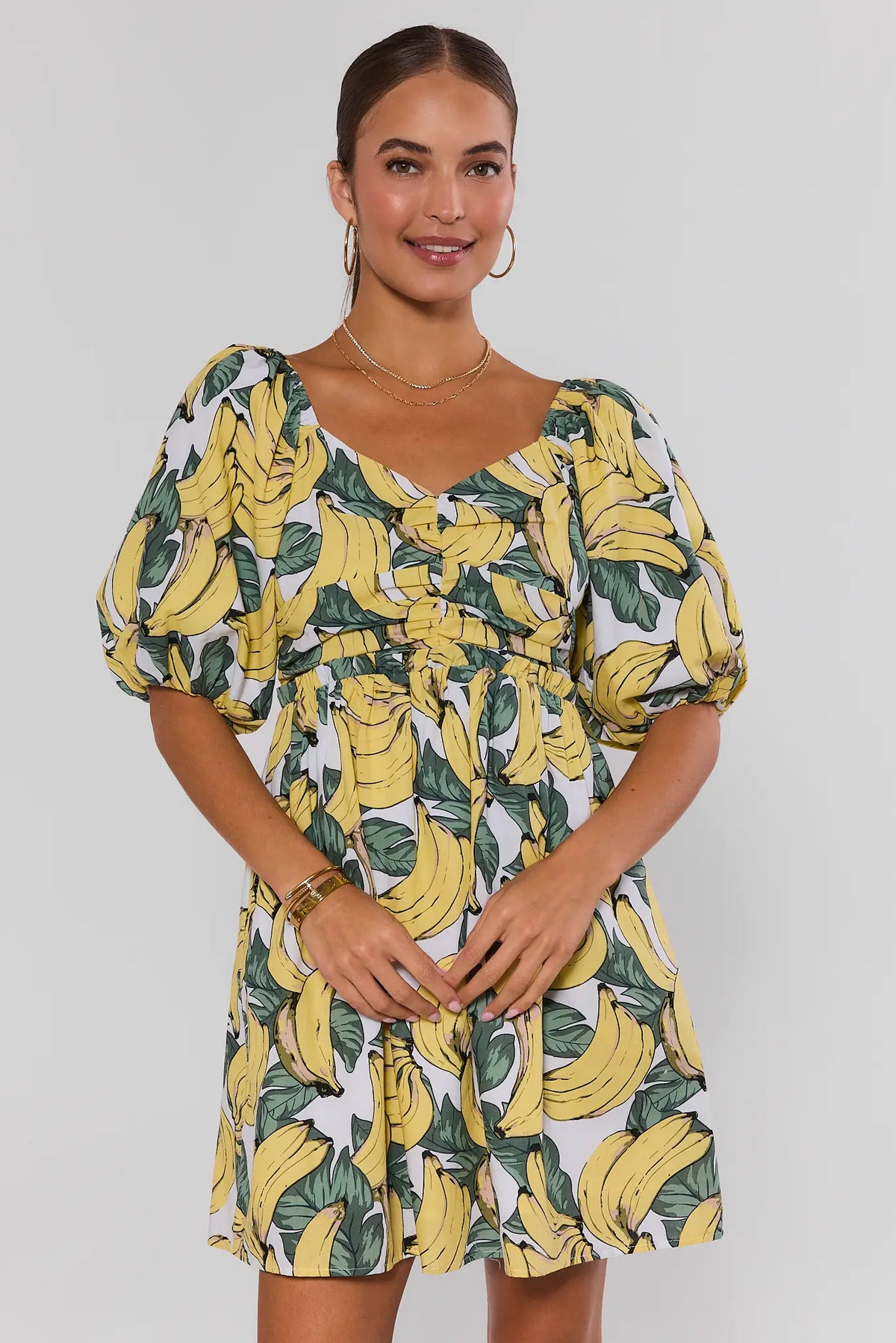 Yellow banana print puff sleeve mini dress - Front View, V-neckline on model | Avara