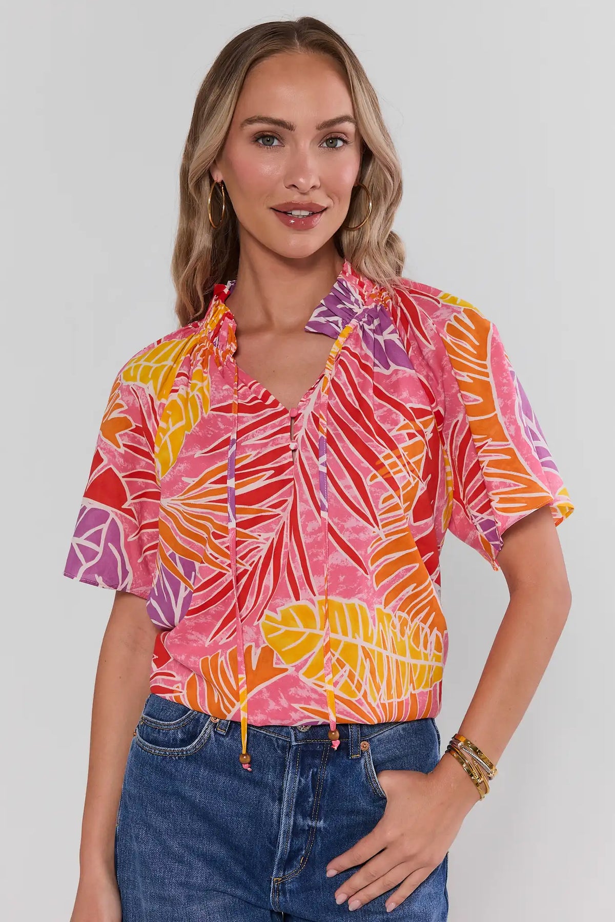 Pink Palm Print Split Neck Top, front view, tropical leaf print with flutter sleeves, paired with denim | Avara