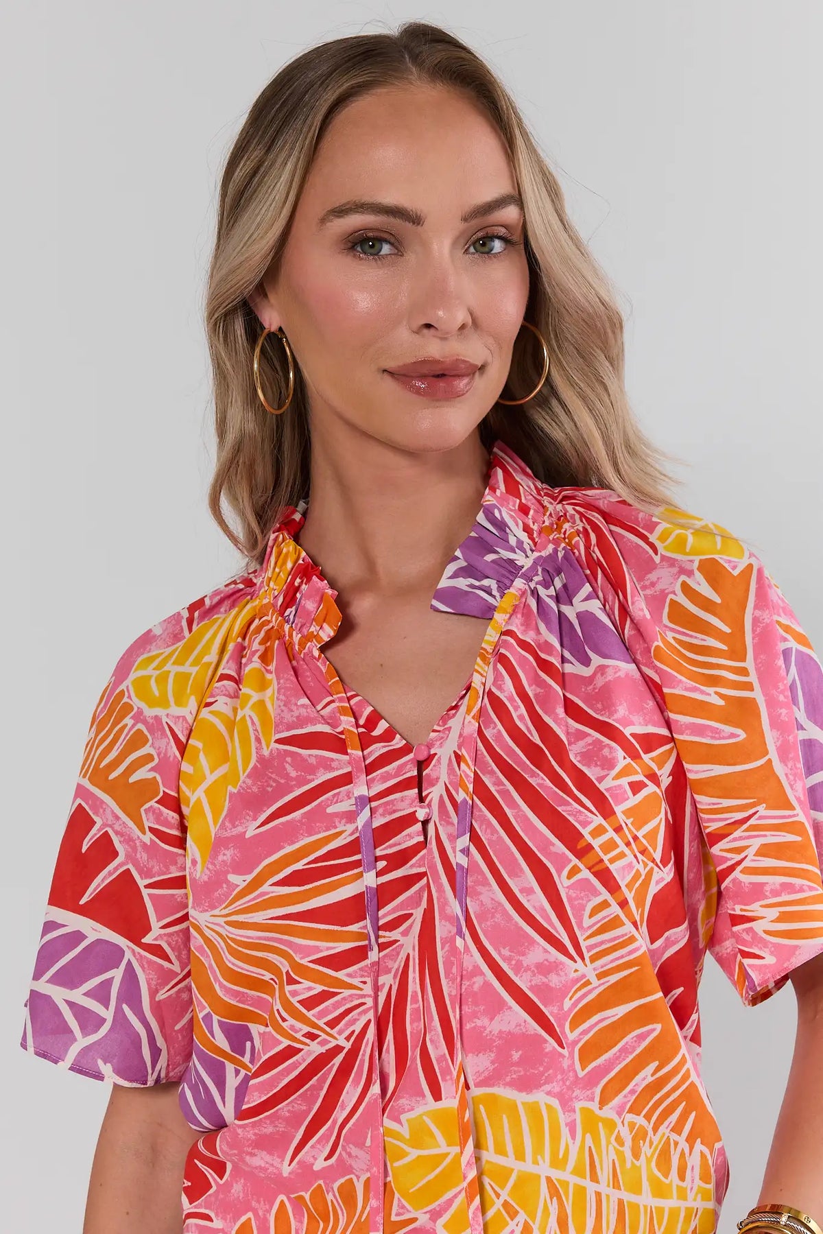 Pink Palm Print Split Neck Top close-up, split neckline with ruched detail and tropical palm print | Avara