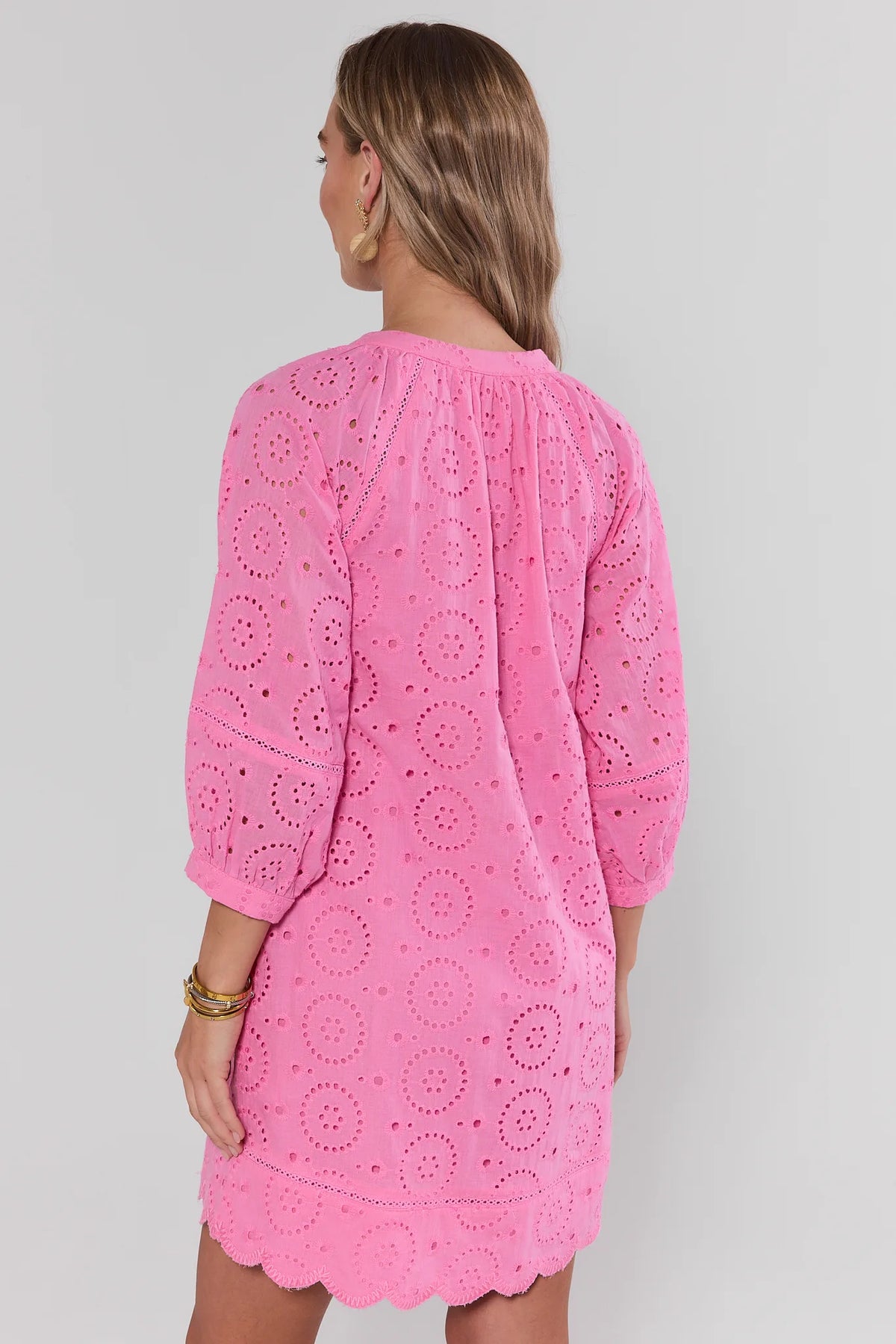 Pink eyelet embroidered short dress - Back View showing scalloped hem and 3/4 sleeves | Avara