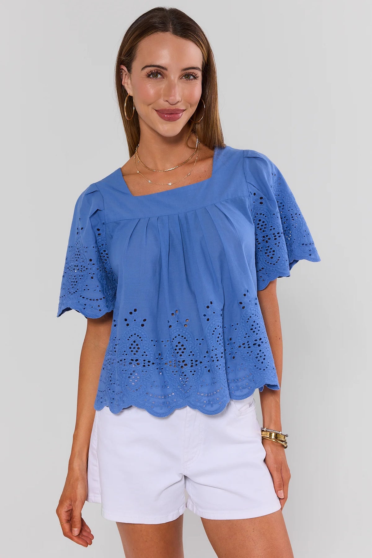 Blue Square Neck Eyelet Top with scalloped hem and flutter sleeves, styled with white shorts - Front View | Avara