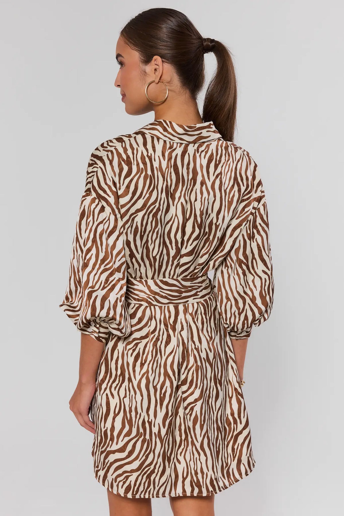 Brown zebra print short dress showing back detail with balloon sleeves and belted waist | Avara