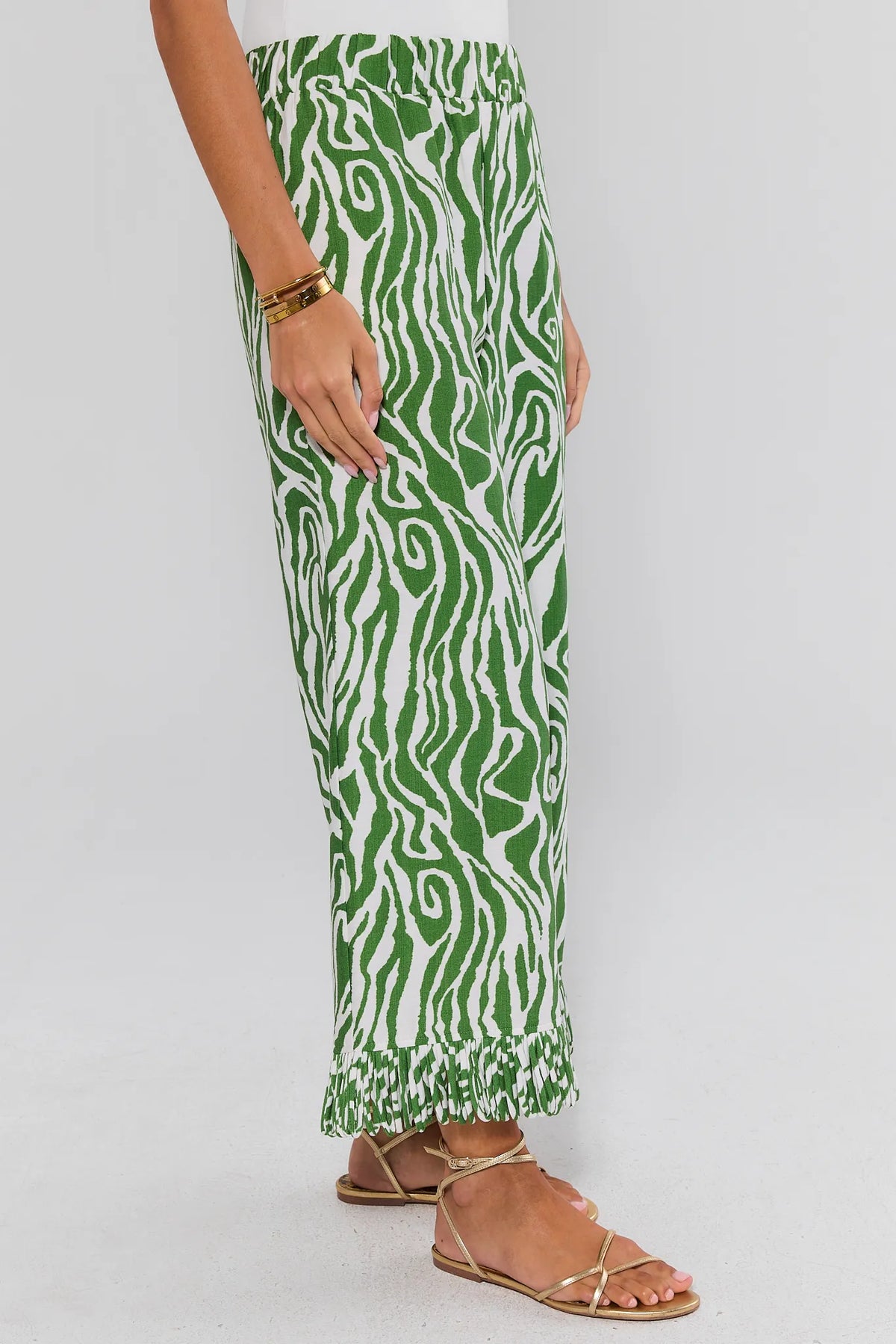Green Zebra Fringe Pants with pleated hem trim, side profile view on model | Avara