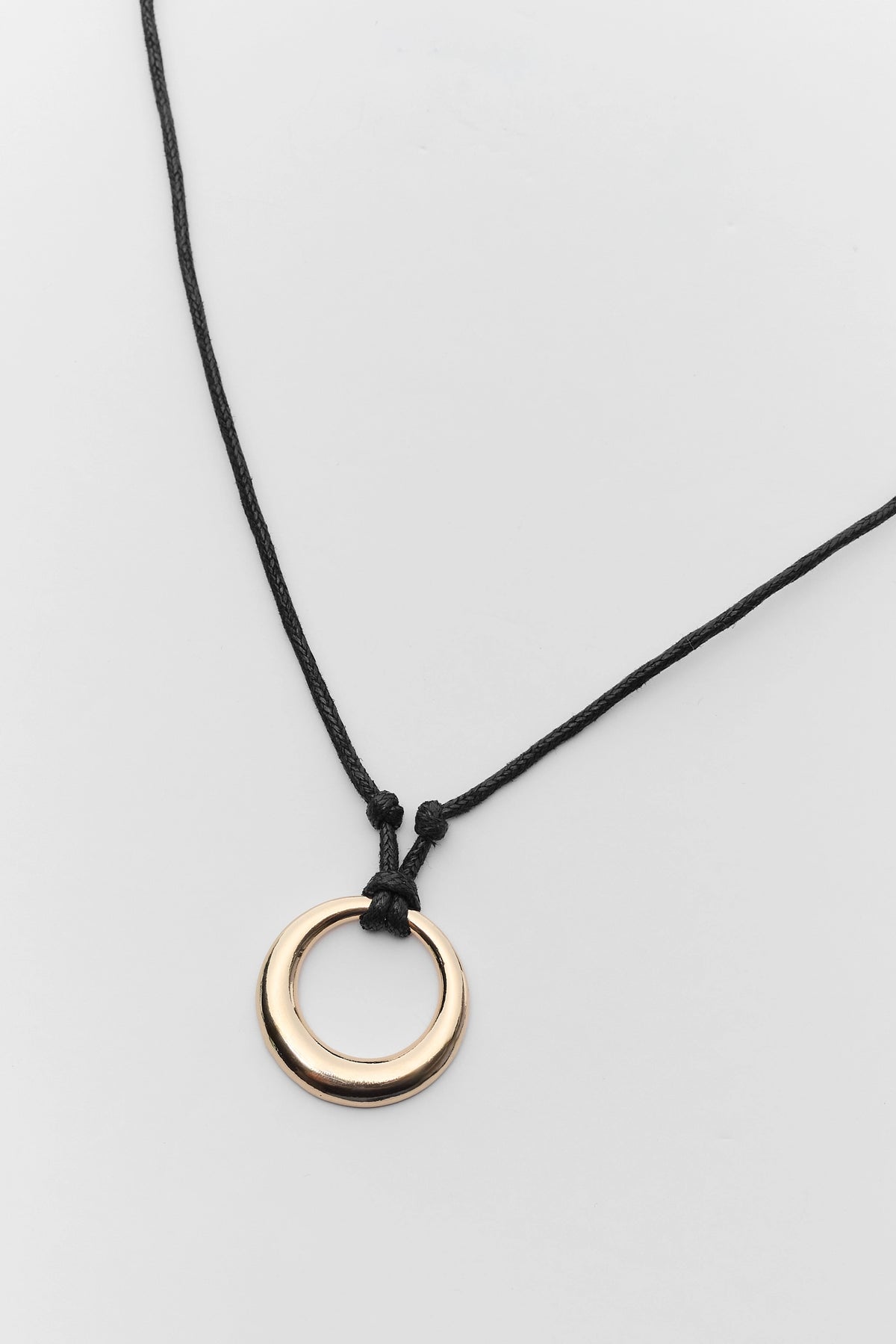 Black cord gold circle pendant necklace close-up showing knotted detail - Pendant Detail | Avara